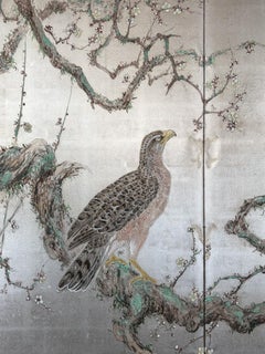 A two-panel silver-leaf screen depicting a hawk on a flowering plum branch