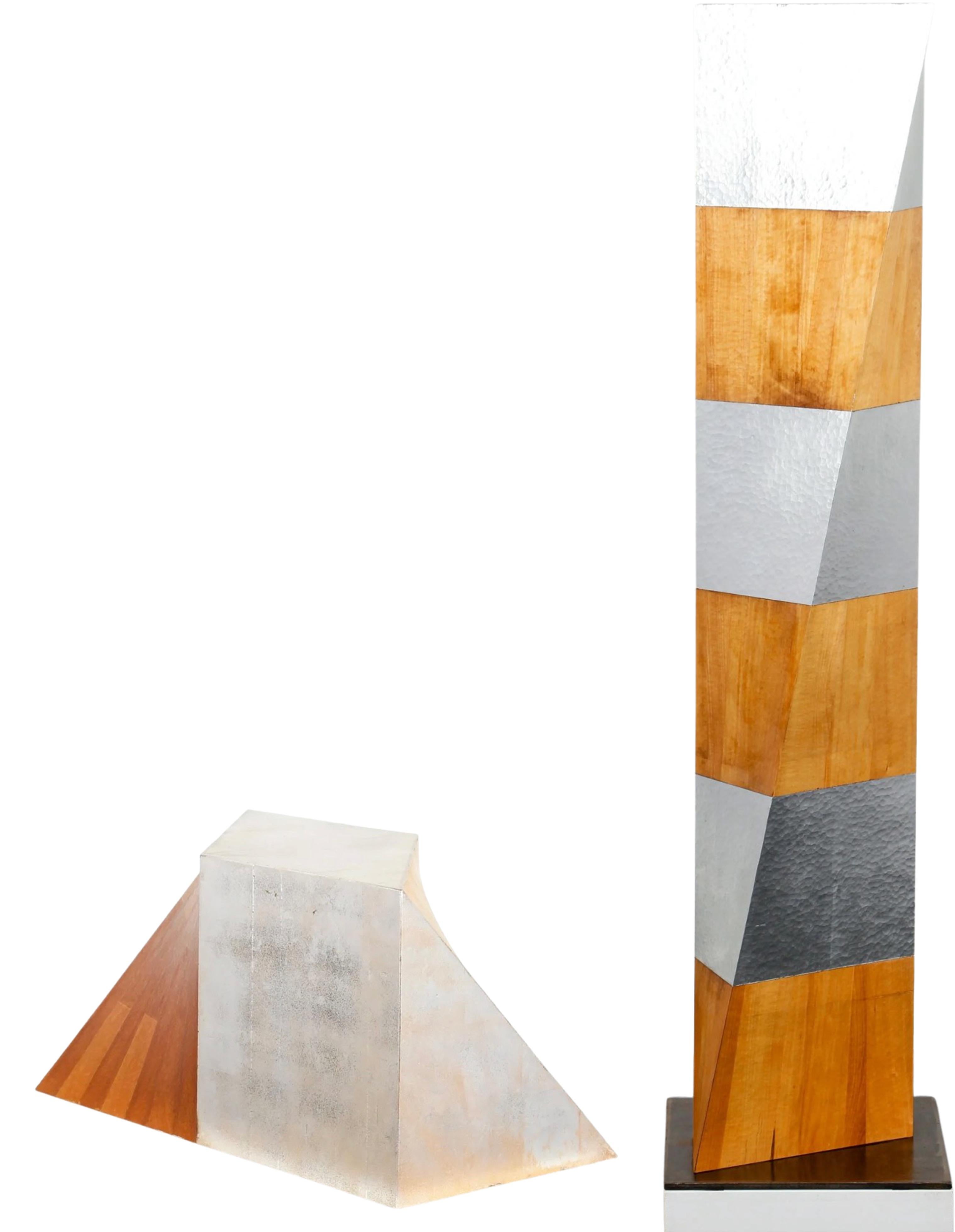 A two-piece sculpture by artist Kevin O'Toole. They are both made of solid maple wood and silver leaf. The tall includes the signature and title on the top edge. The short one includes the signature and title on the back edge. Both sculptures are