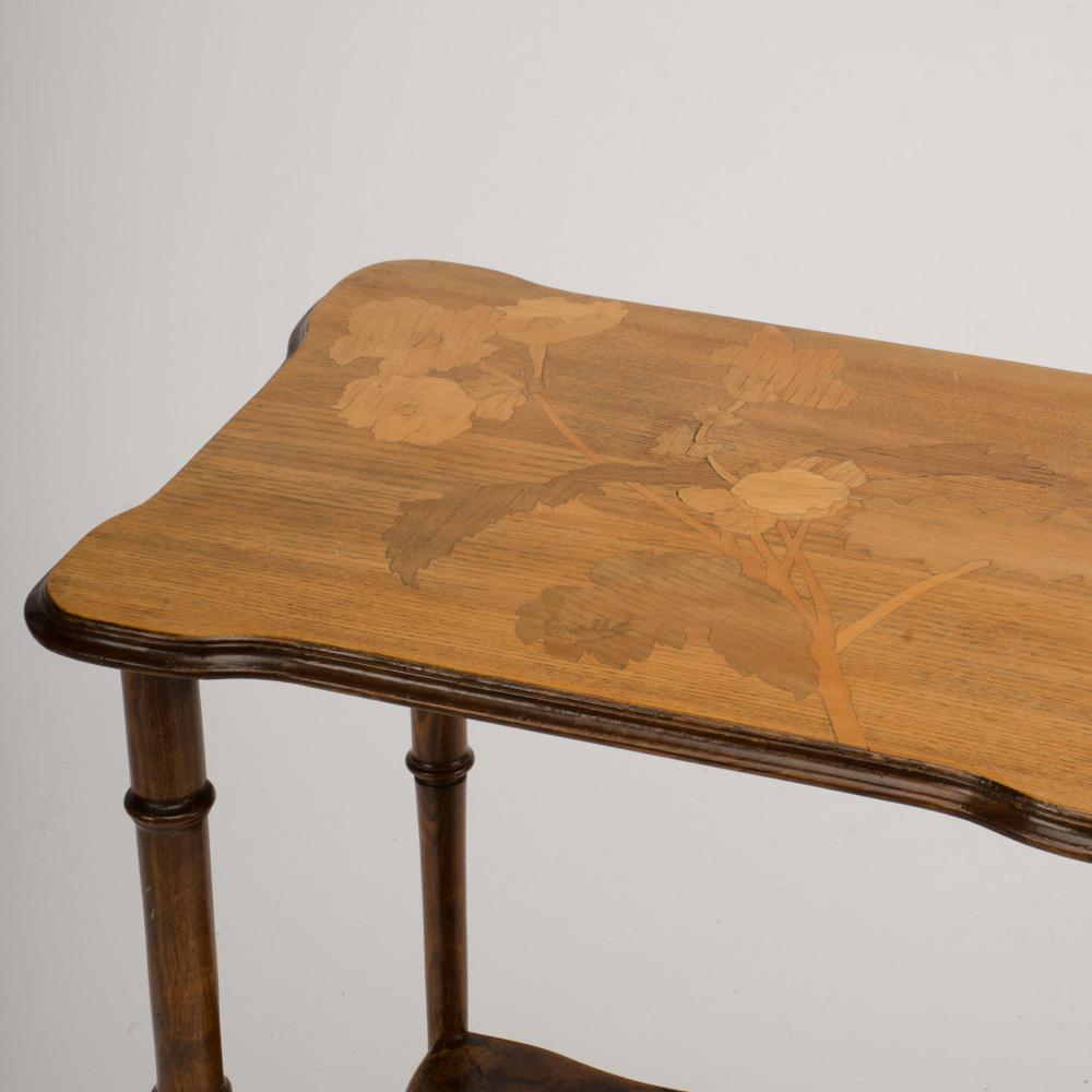 A charming two-tier French occasional table with parquet top, raised on 4 turned legs. 19th century.