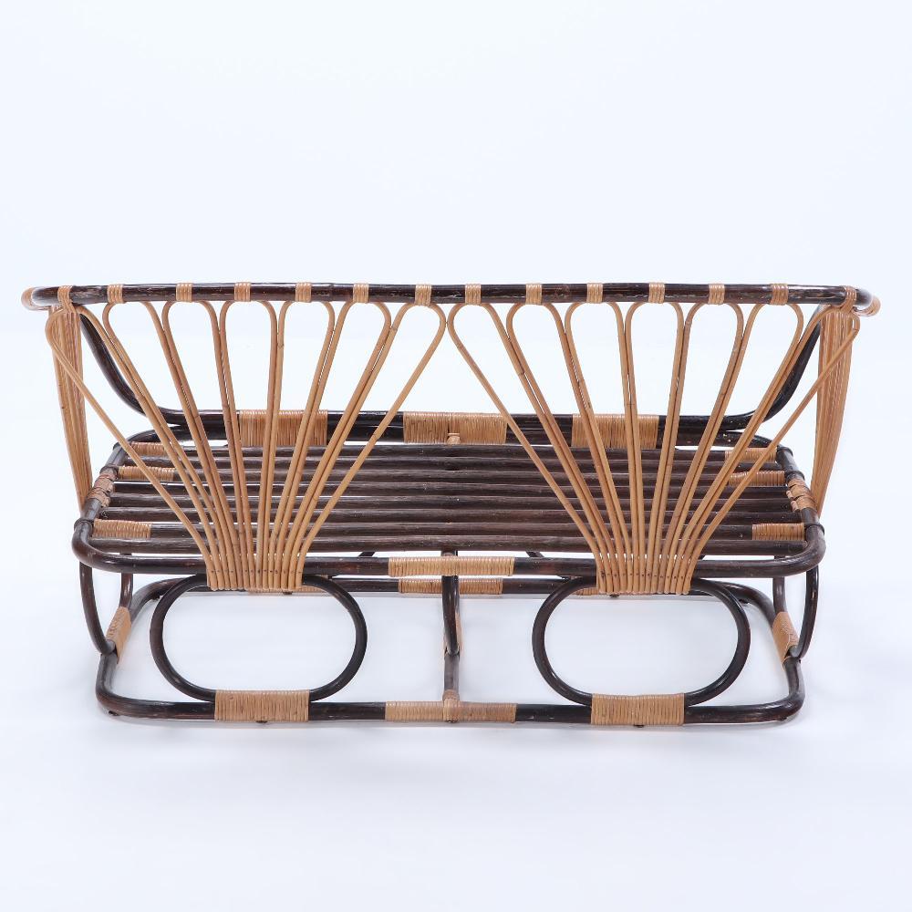 A two-tone French rattan settee with cushions. Circa 1970 1