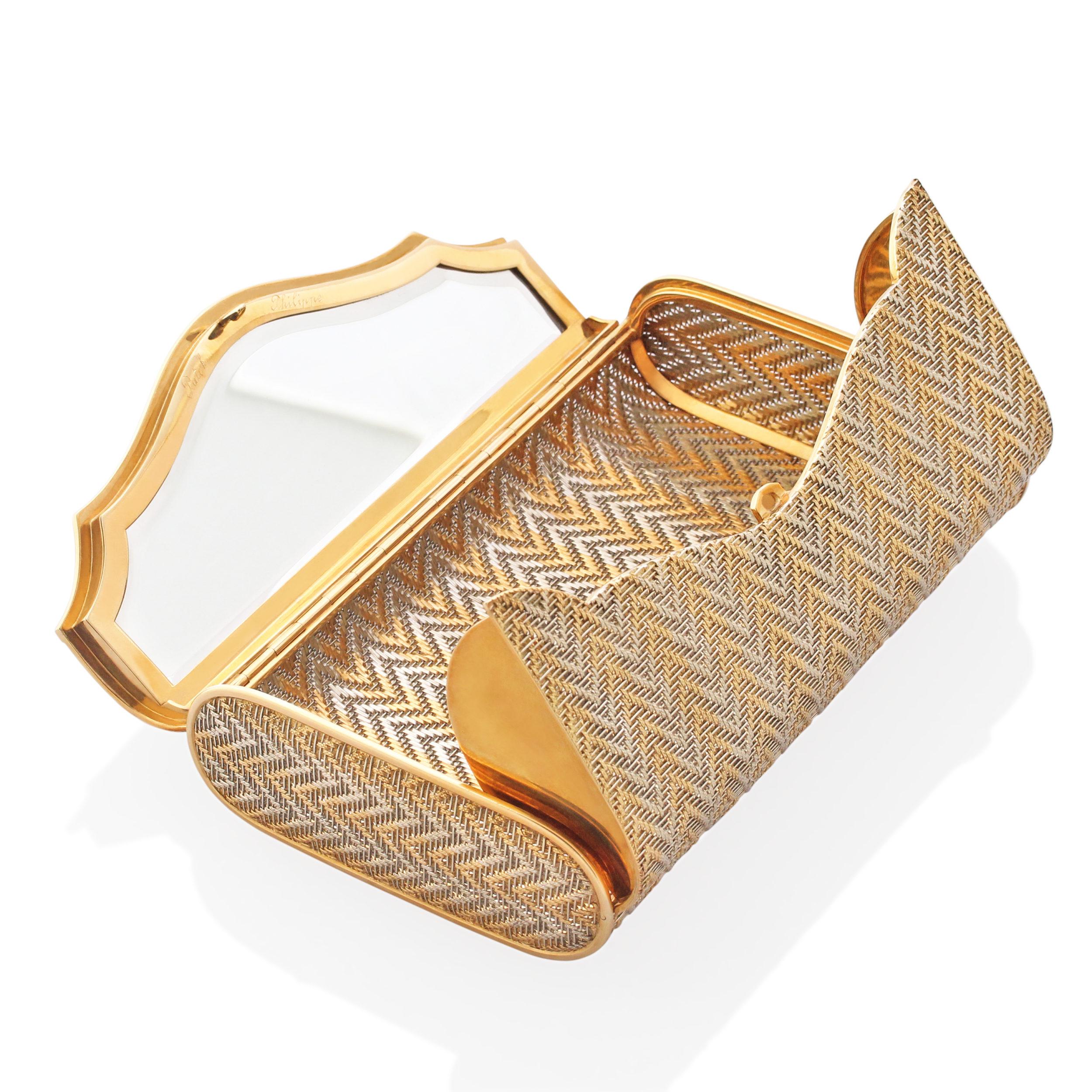 A gorgeous two tone gold clutch bag by Patek Philippe. Crafted from threads of 18k yellow and white gold woven together in an interchanging zigzag pattern to create this gorgeous light mesh evening bag. Compact enough to fit all your evening