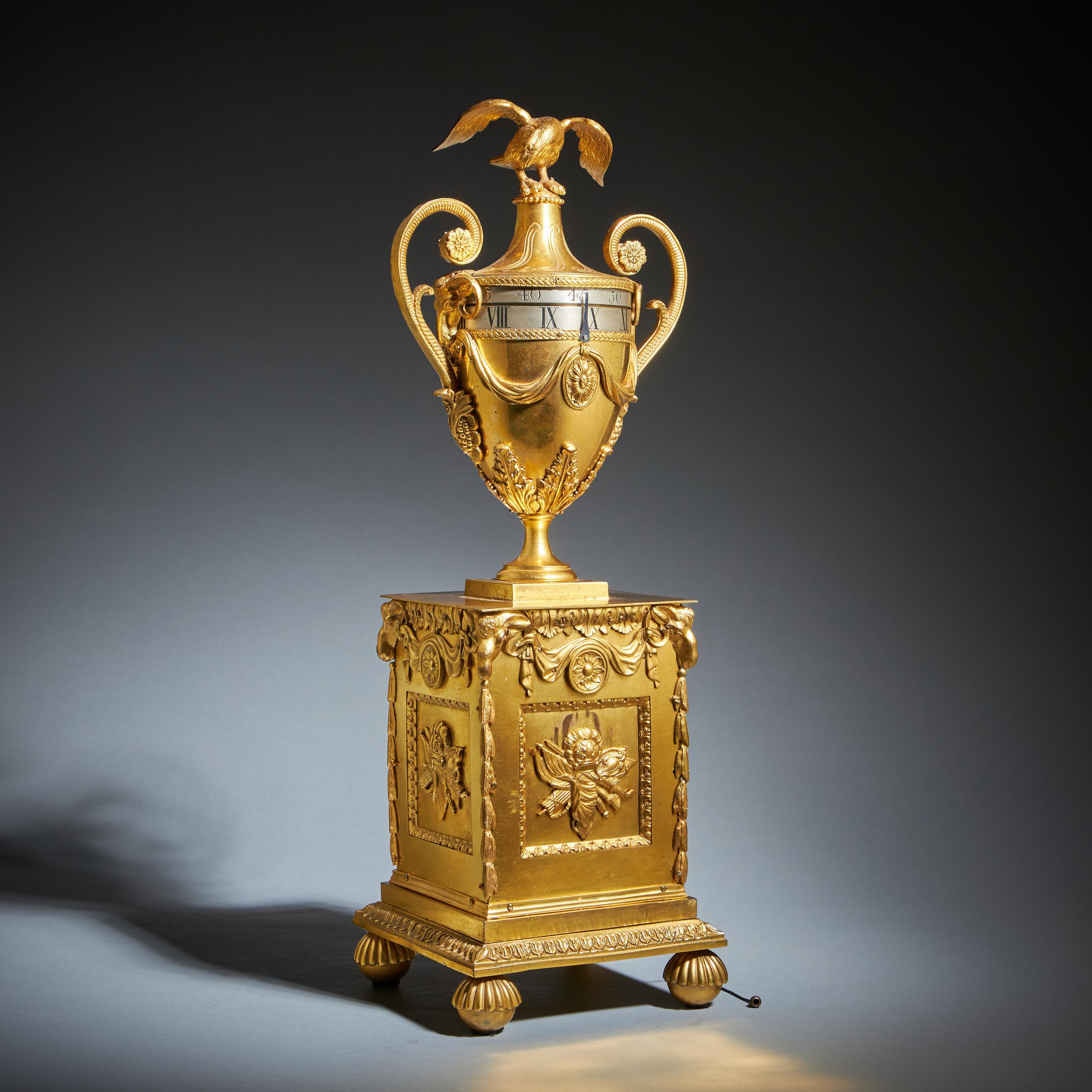 A unique and exceptional neoclassical urn clock by Paul Rimbault, London, circa 1770. This singular example of a pendule à cercles tournants stands as a masterpiece of English clockmaking and design from the Georgian period.

The ormolu case is of