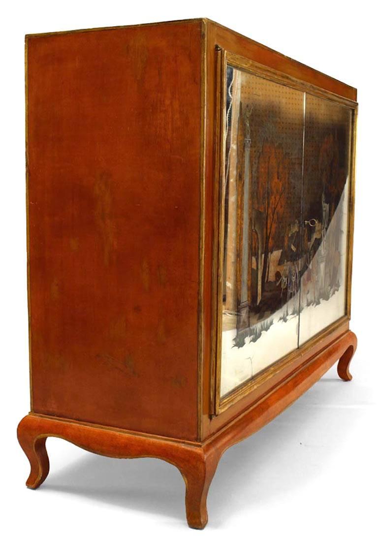 French 1940s orange lacquered commode with 2 painted mirror doors with Neo-classic scene and brass trim. (Mirror decorated attributed to ADRIEN EKMAN)

