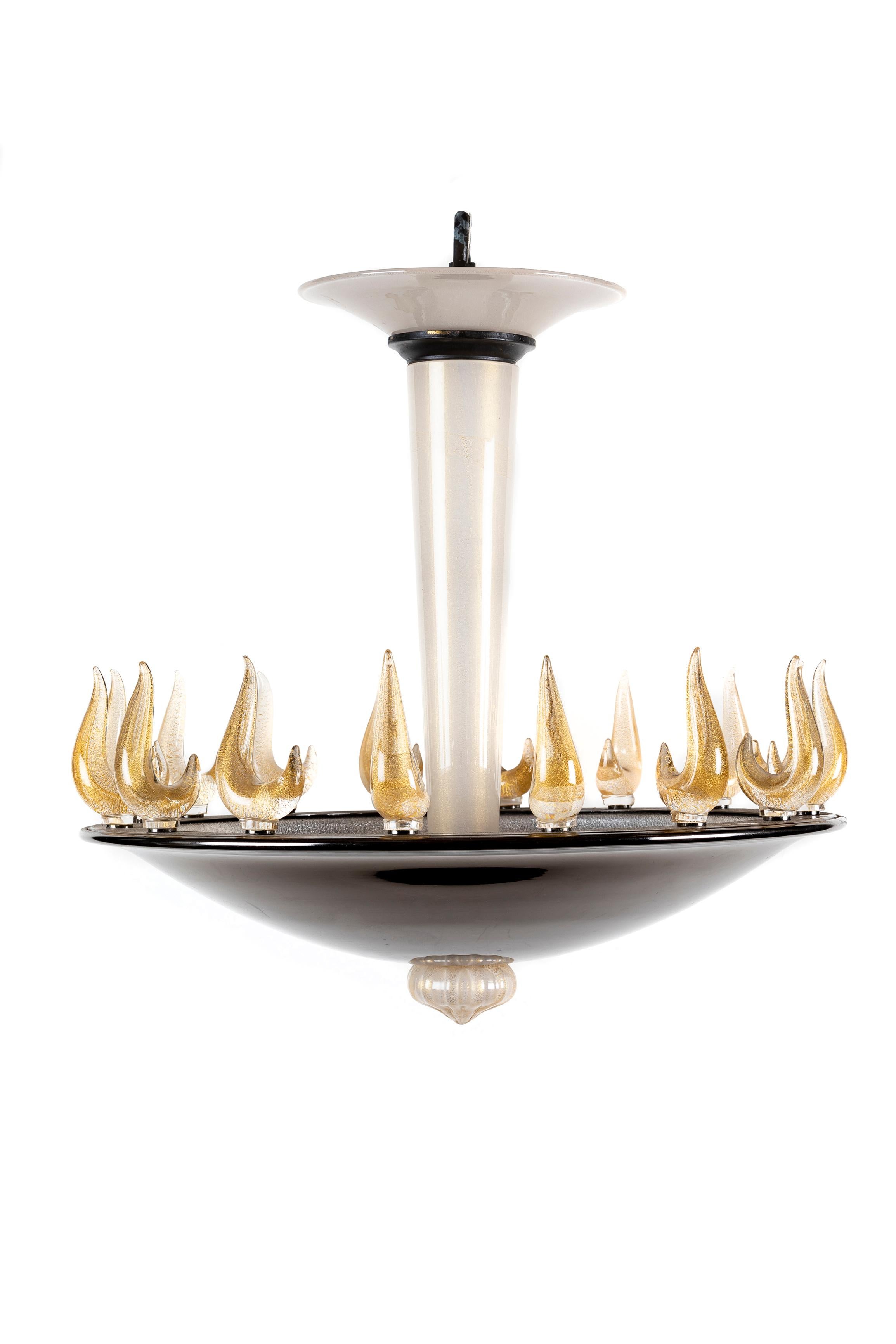 A Spectacular and Large Unique Antique Art Deco Gold Murano glass circular Chandelier of exquisite craftsmanship. This very unusual Murano glass chandelier is embellished with multi large hand blown gold murano glass flames mounted on a patinated