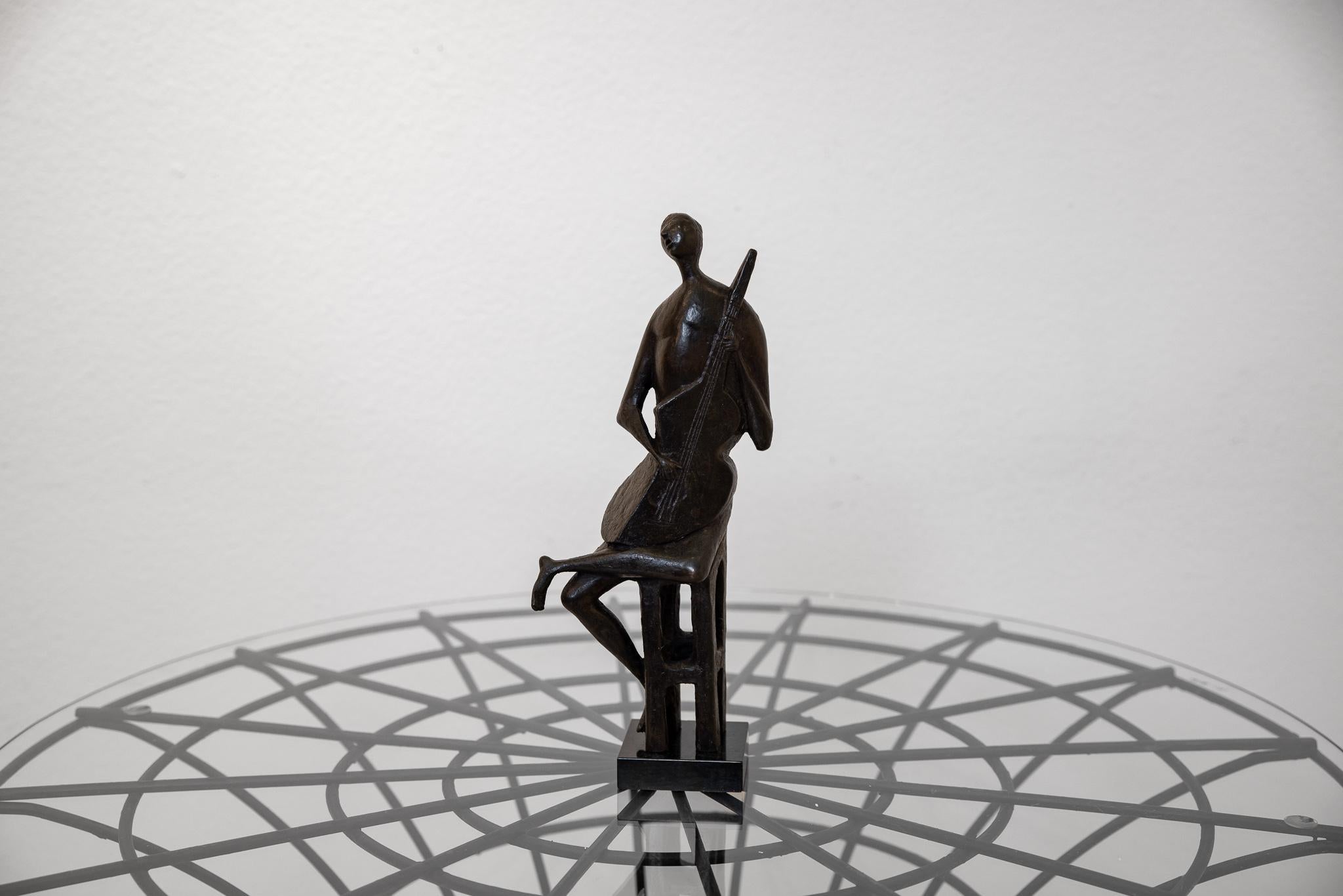 This is a unique bronze piece, not editioned, by Marchello Mascherini of a seated figure on a stool playing a guitar. One may interpret the figure as singing as his mouth is open. The figure and the guitar blend and become one in areas, creating