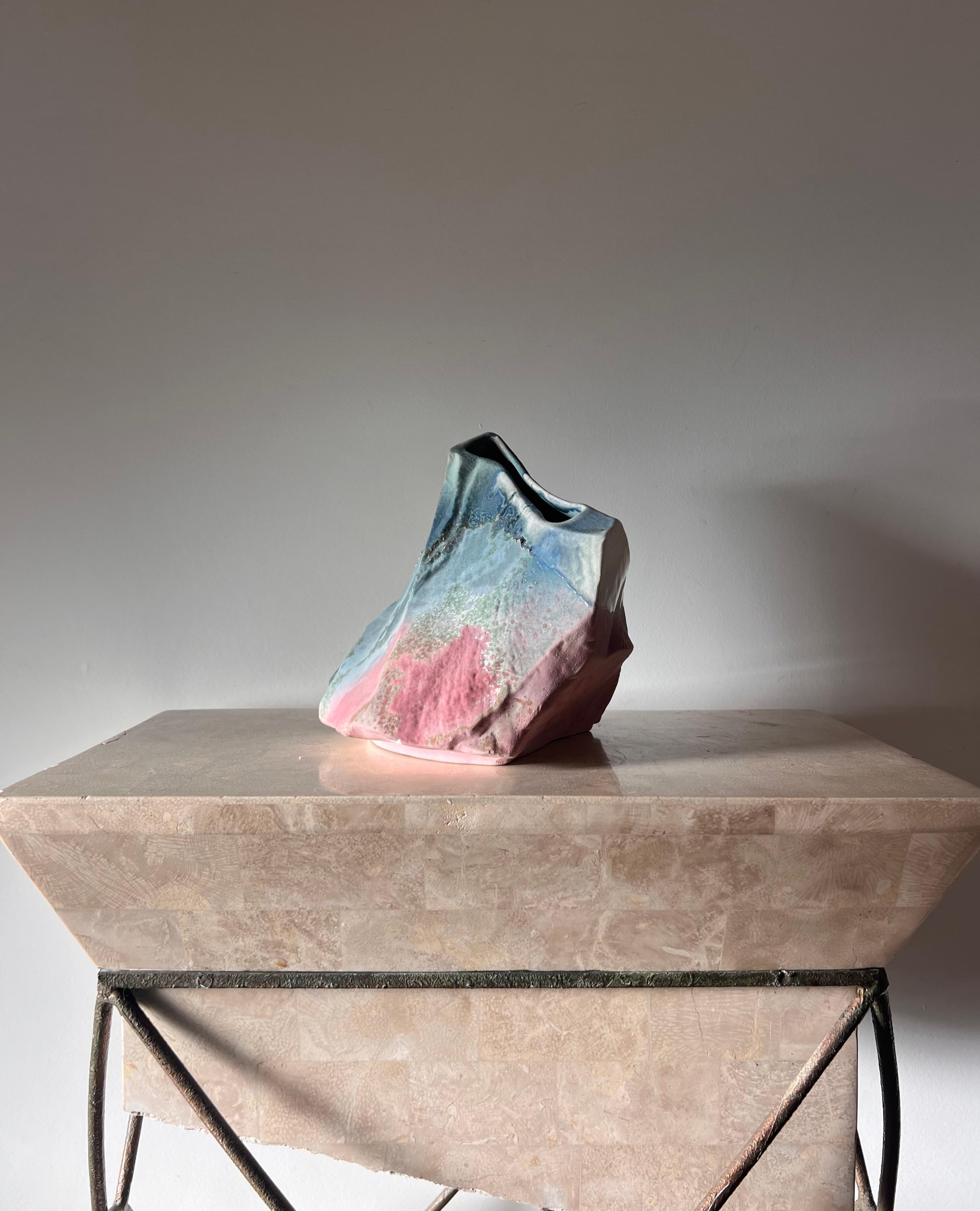 A absolutely stunning and wildly unique ceramic vase - art piece really - by Tony Evans, signed, late 20th century. Featuring an idiosyncratic lava glaze over scintillating pigments and boulder-like shape, hallmarks of Evans’ work. Tones of azure,