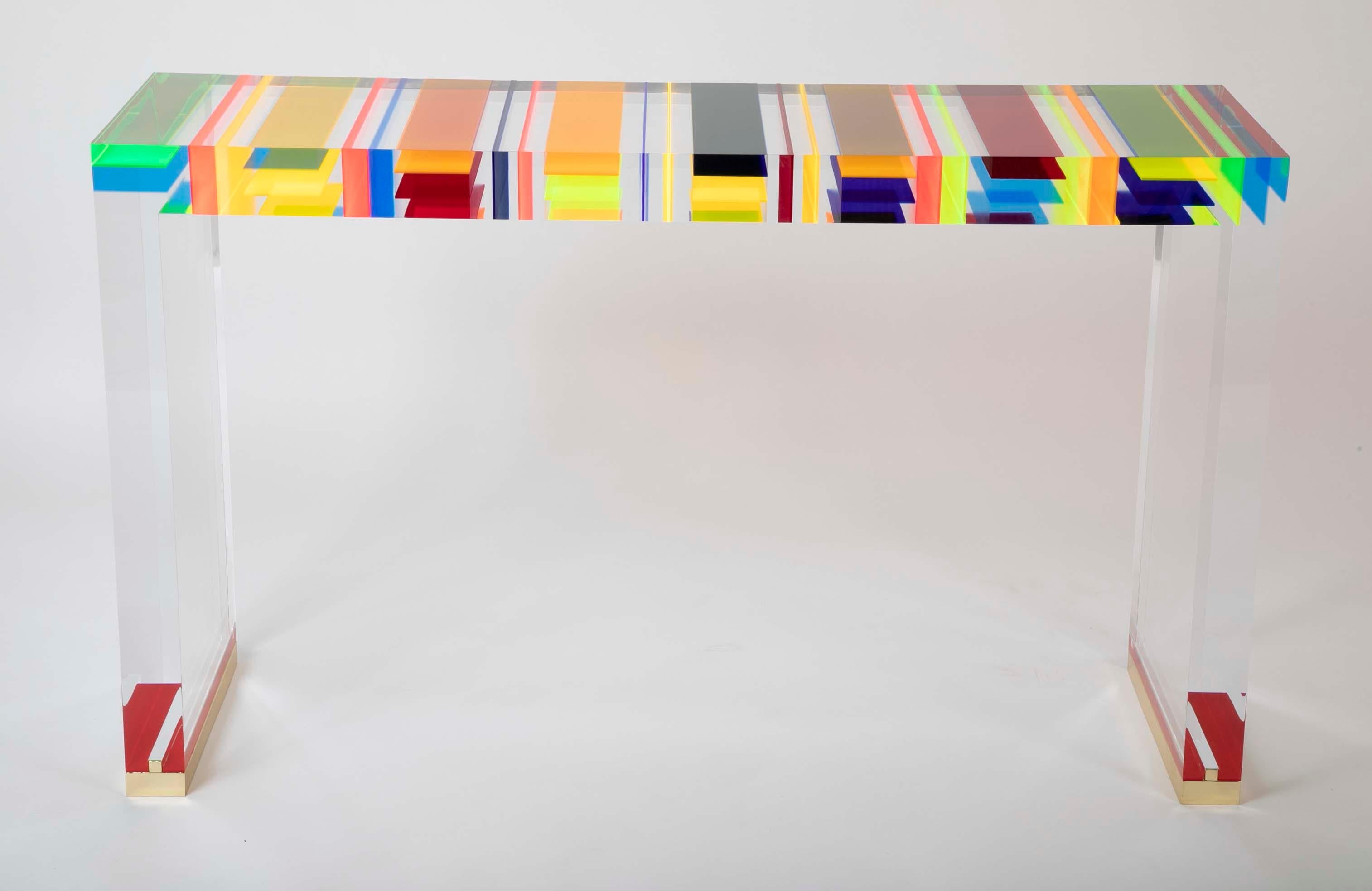 A striking Italian console table with stripes of thin multicolored translucent encased resin. Produced circa 2017.