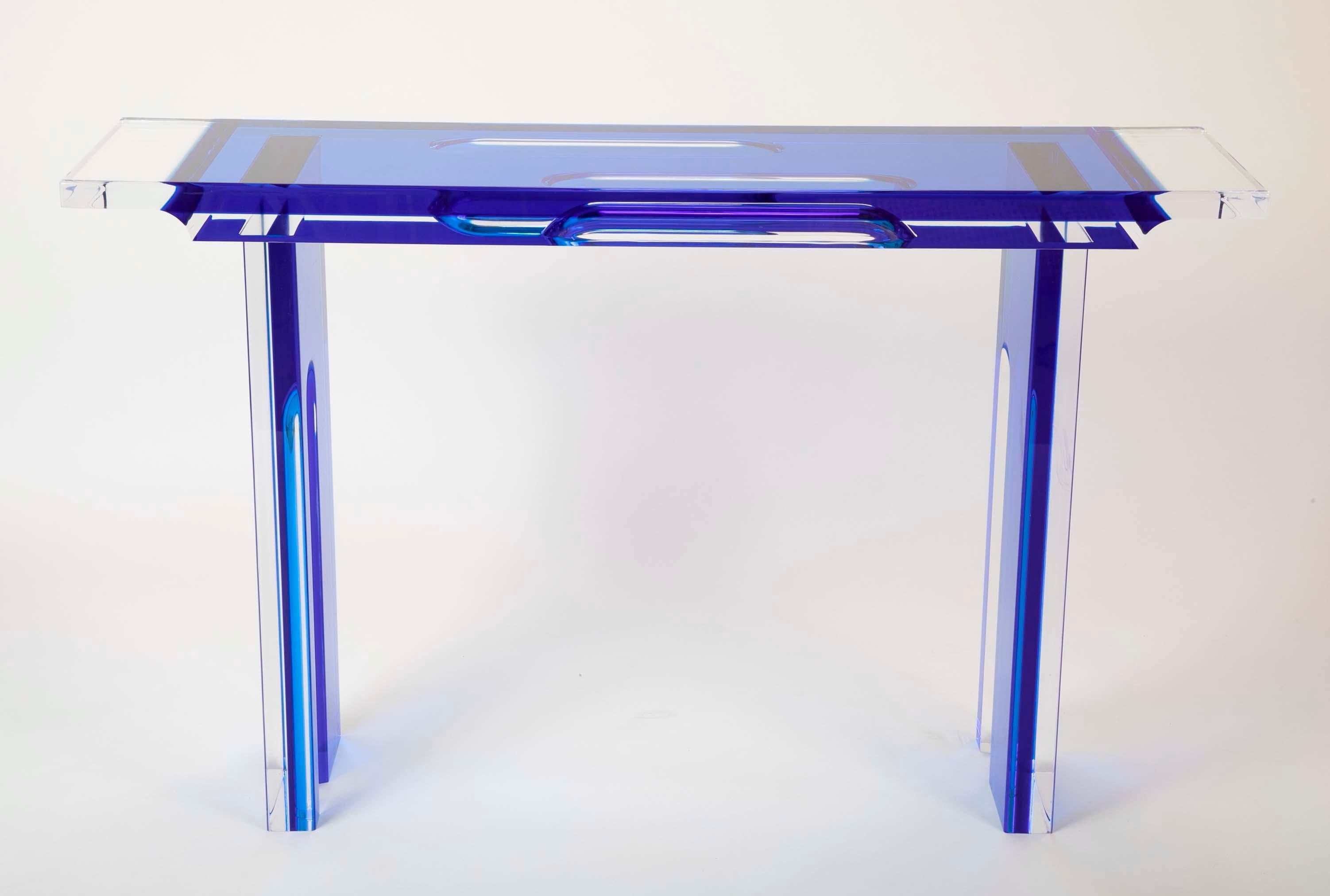 A sleek console table with translucent oval cut impressions to underside.
