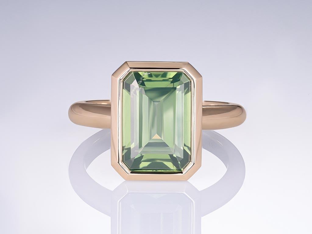 Discover unparalleled elegance with our exquisite ring featuring a rare 7.40-carat green zircon, sourced from the enchanting landscapes of Sri Lanka. Set in 18k champagne gold, this ring showcases a central gemstone that captures the essence of