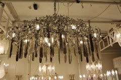 A unique hand made chandelier in nickel steel, smoked & clear rock crystal
