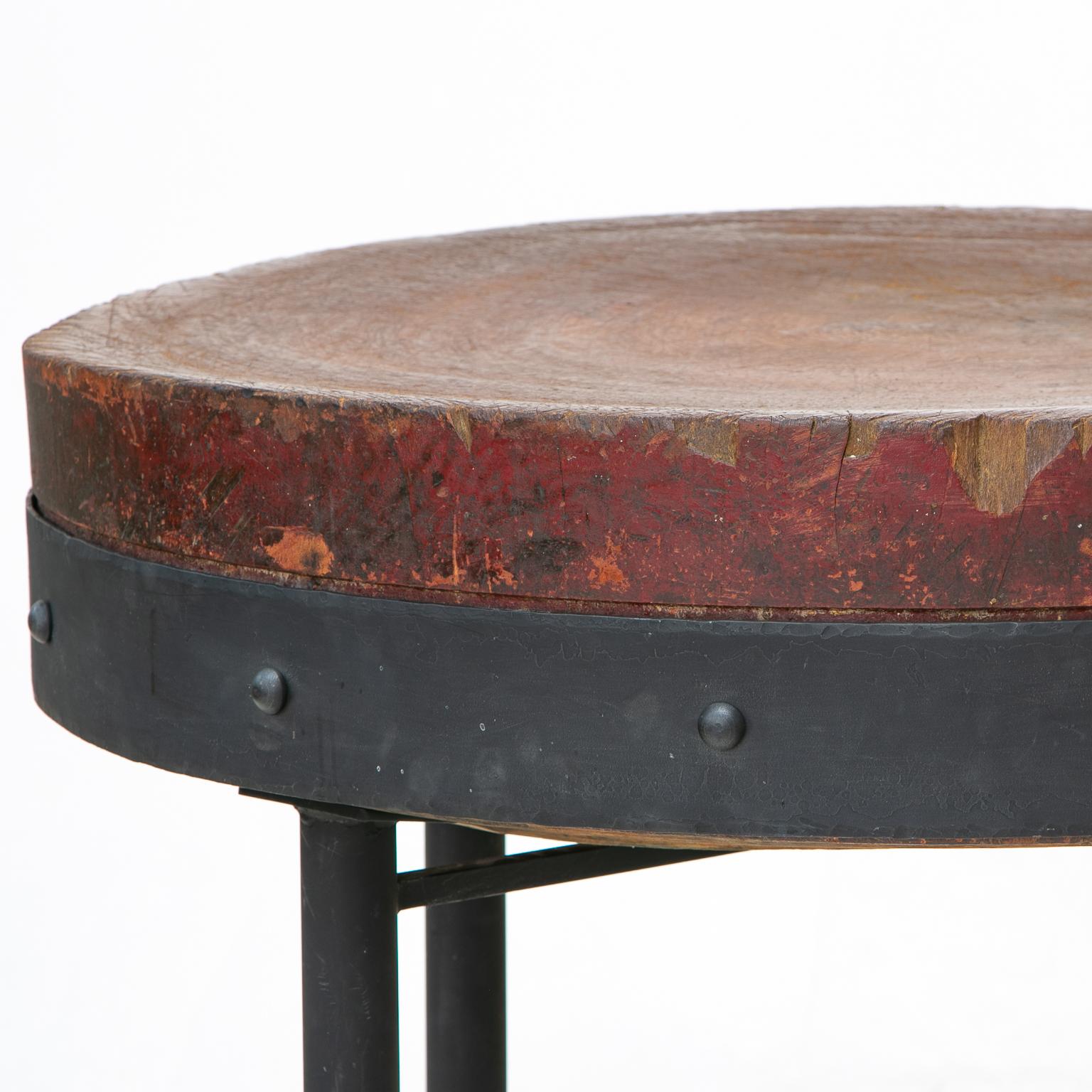 This is a very unique round butcher block top from one solid cut wood from a tree. The iron base was made for the top by a notable ironsmith in Nashville, TN. Very sturdy and well preserved. The previous owner applied butcher block oil once a week