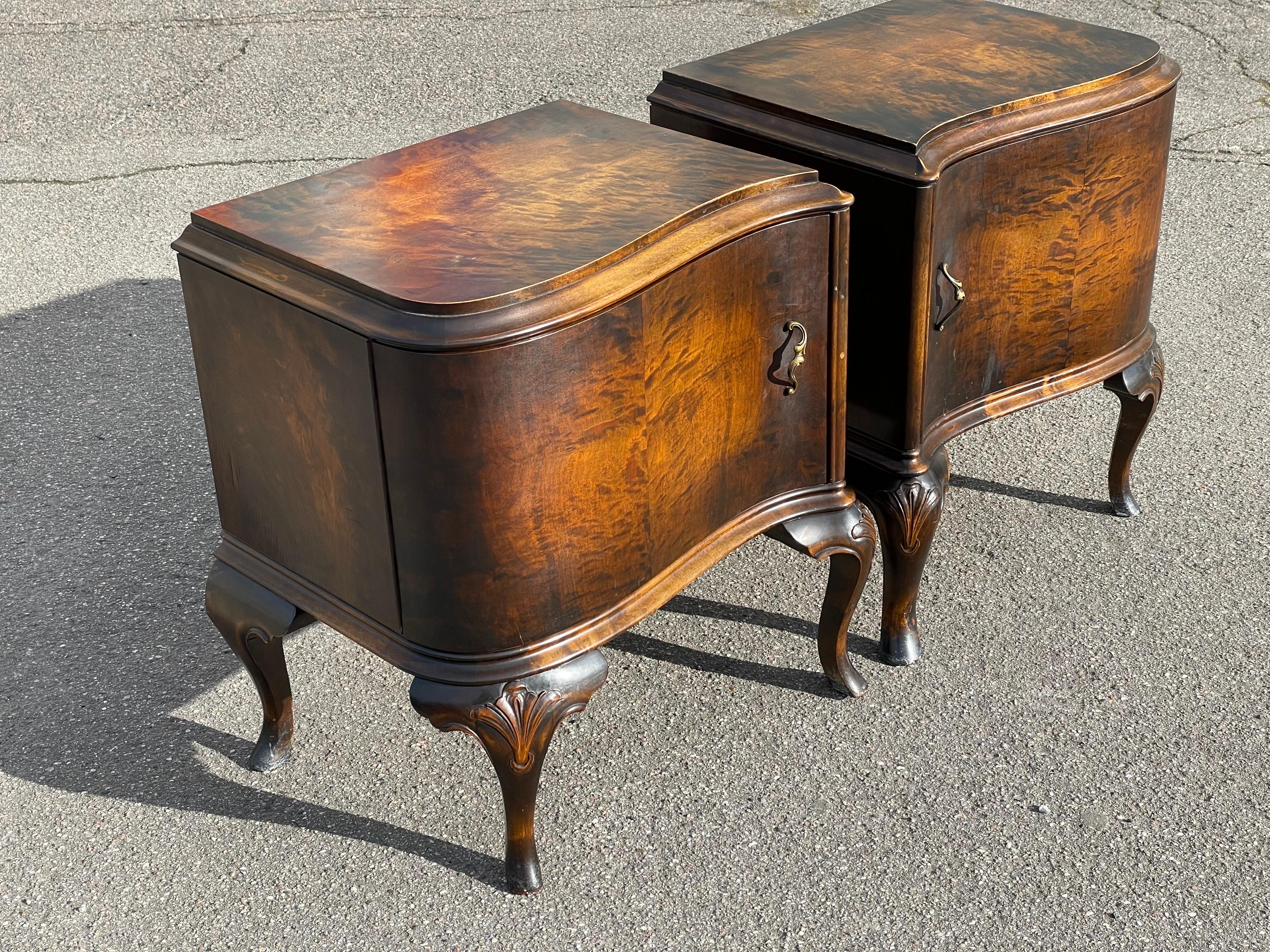 These stunning, 1930s, nightstands are a true reflection of eclectic Art Deco style with a Hollywood Regency twist. Crafted from rich, warm walnut wood, they boast a perfect balance of vintage charm and modern functionality. Their unique design