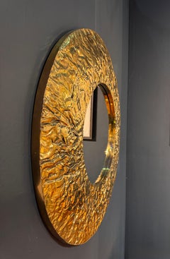 A unique textured brass circular Art mirror