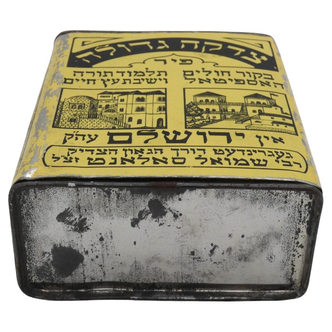 A charity container designed by Alfred Salzman for the United Charity Institution of Jerusalem in 1920 is an intriguing artifact, reflecting the historical, cultural, and charitable contributions of the community of that time.

The United Charity