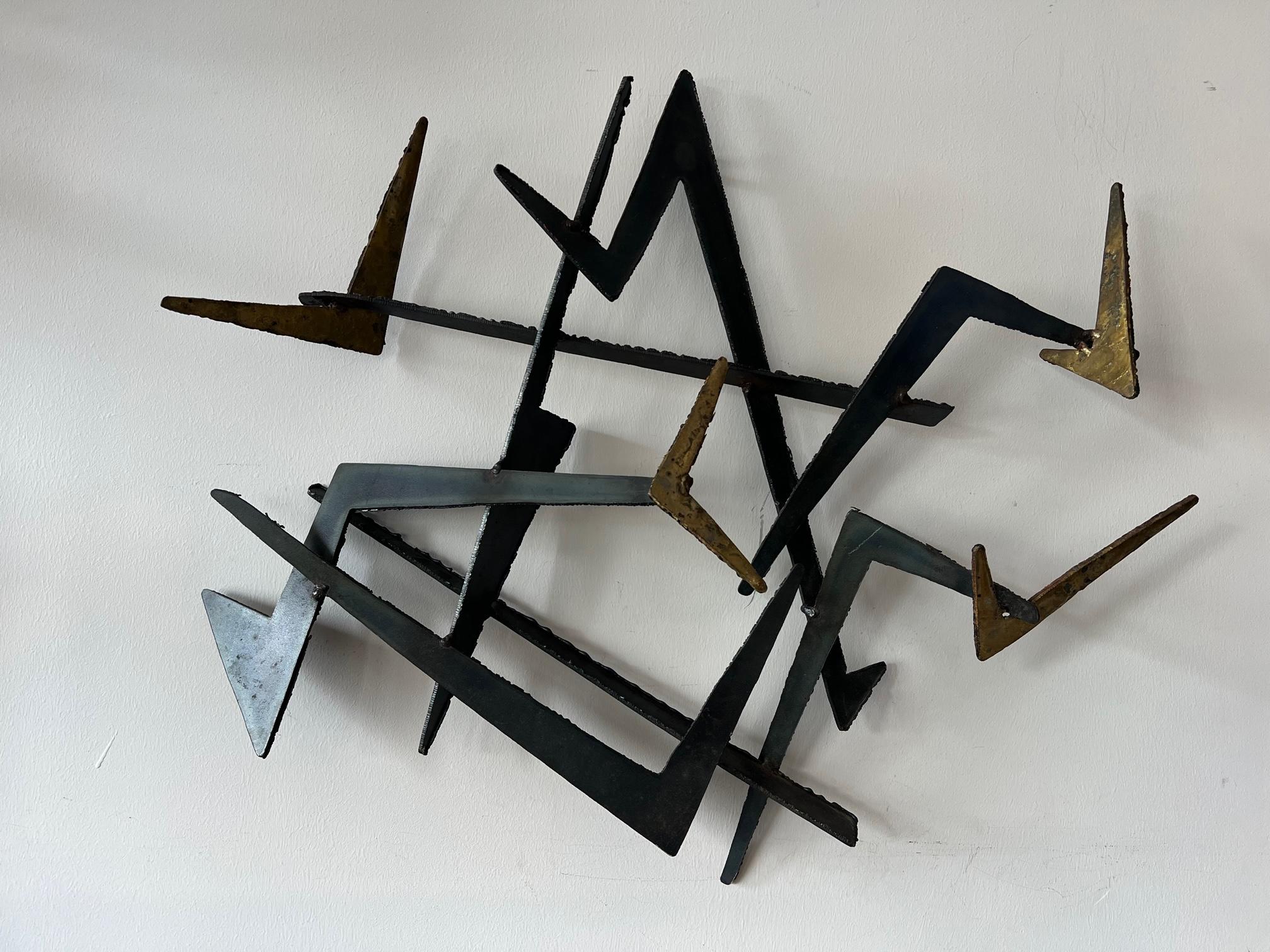 An unusual steel-torch cut and welded sculpture. Brutalist and jazzy. Unsigned. Heavy thick steel with patina and some areas gilded.