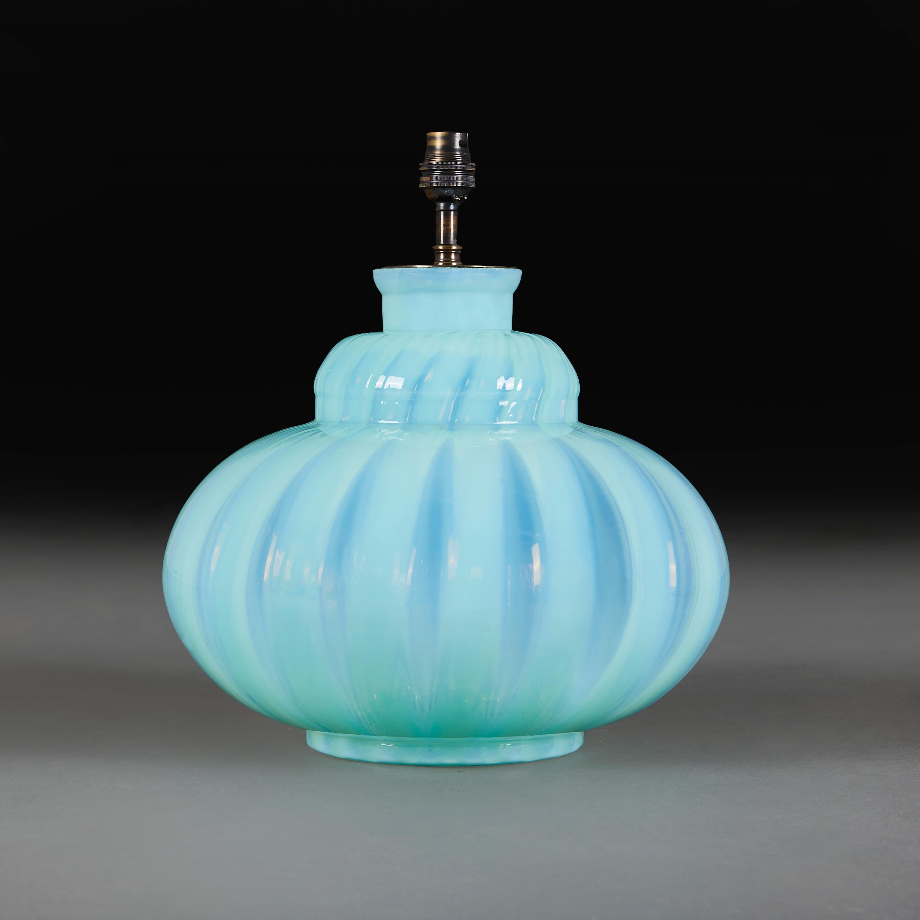An unusual mid-twentieth century Murano vase in uranium glass, of large gourd form, with a gadrooned surface.

Please note:

Lampshade not included. Lamp is photographed with an 18” diameter pale cream card Pembroke lampshade.

Currently wired for