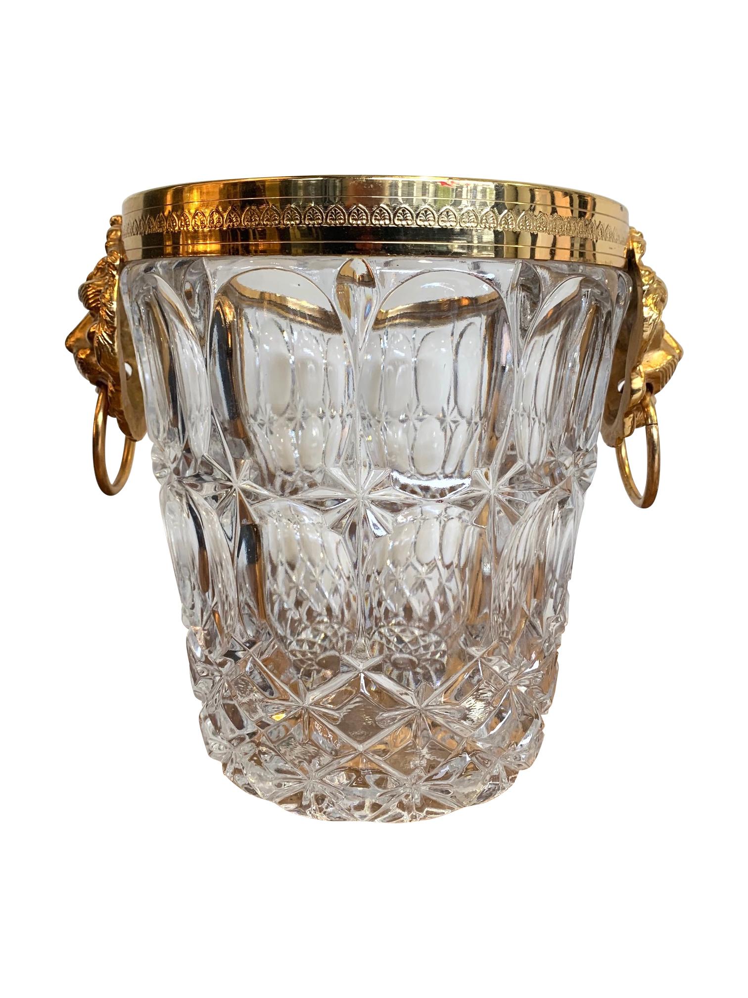 A fabulous Val Saint Lambert crystal champagne bucket with thick crystal bowl with scolloped patterns and gilt metal lion head handles and engraved top rim.