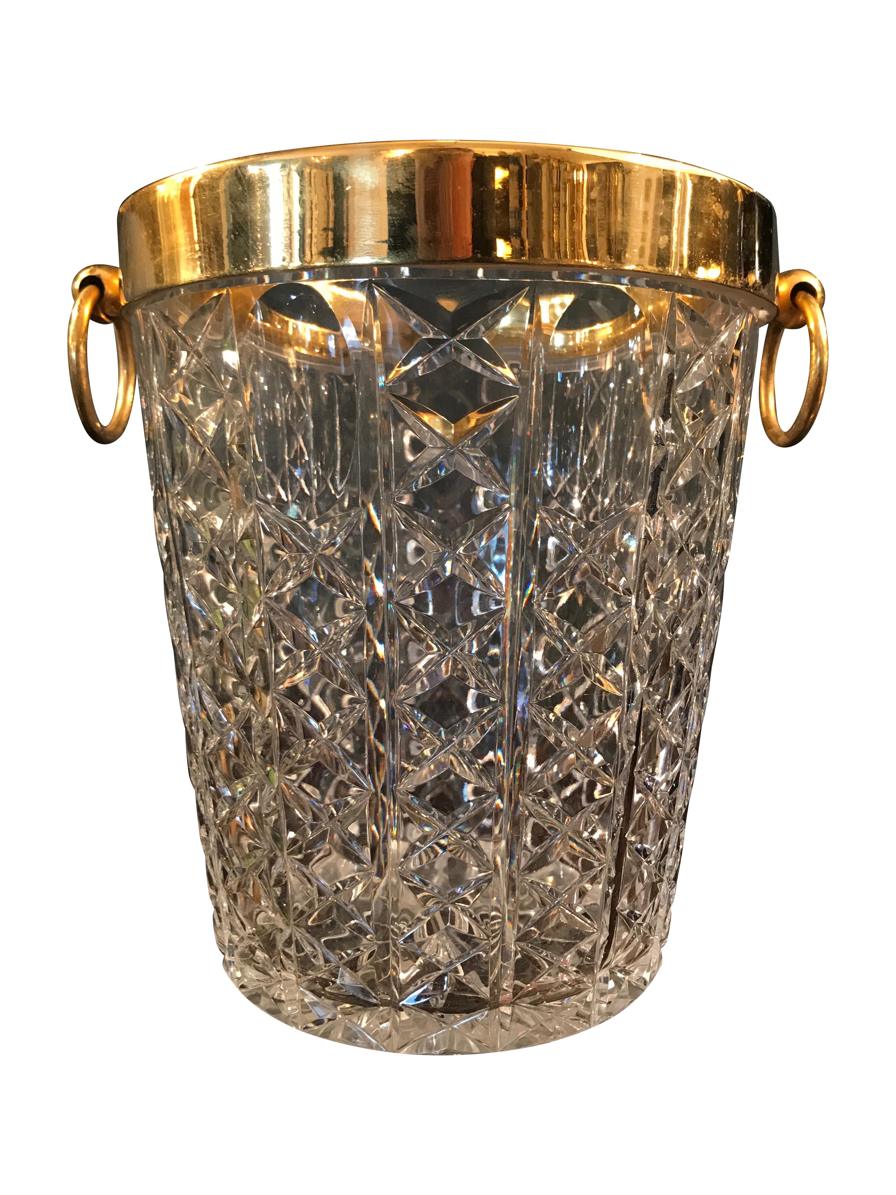 A Val St Lambert cut crystal champagne bucket with gold plated rim and hooped handles.