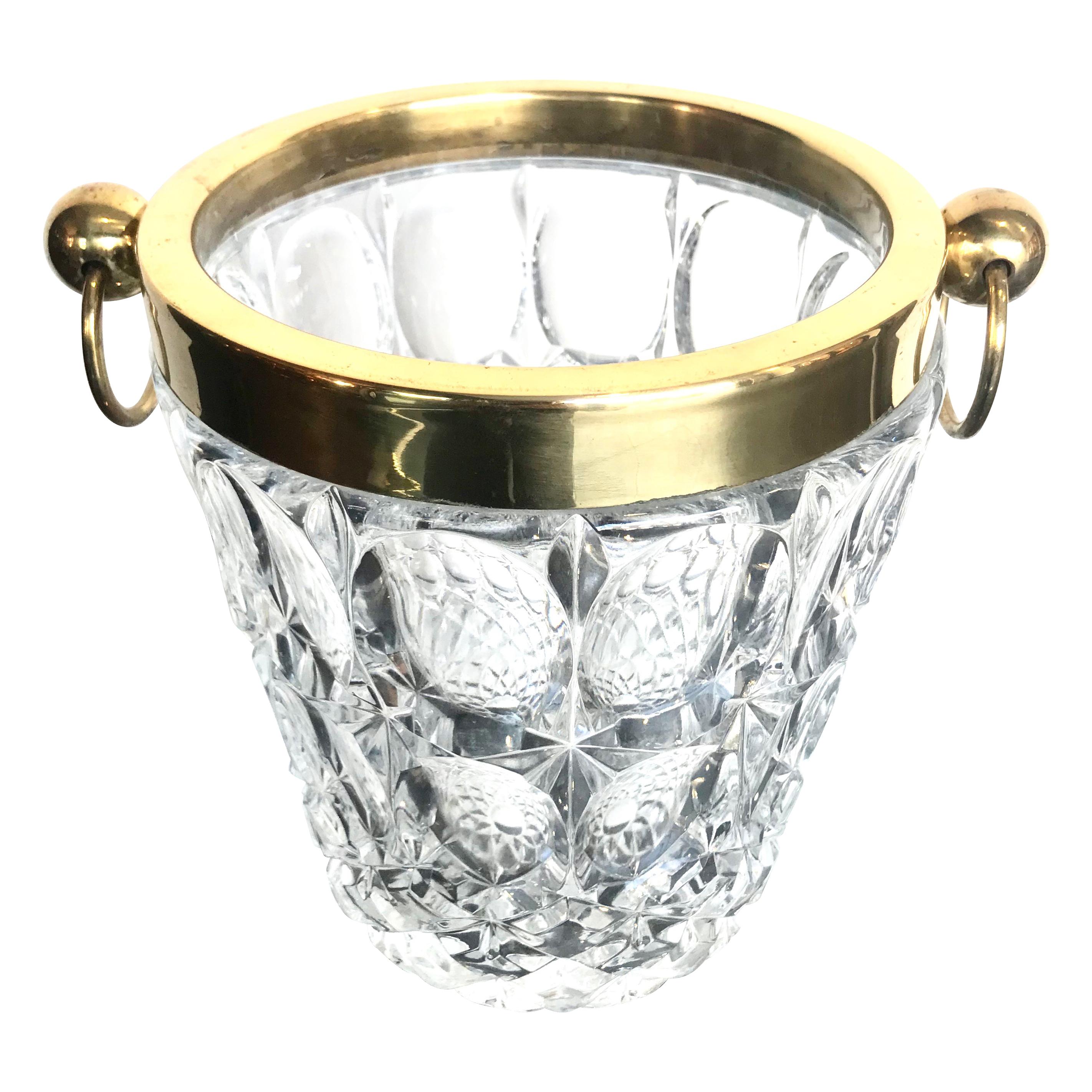 A Val St Lambert crystal ice bucket with oval patterned detail in the glass, with brass top and handles.