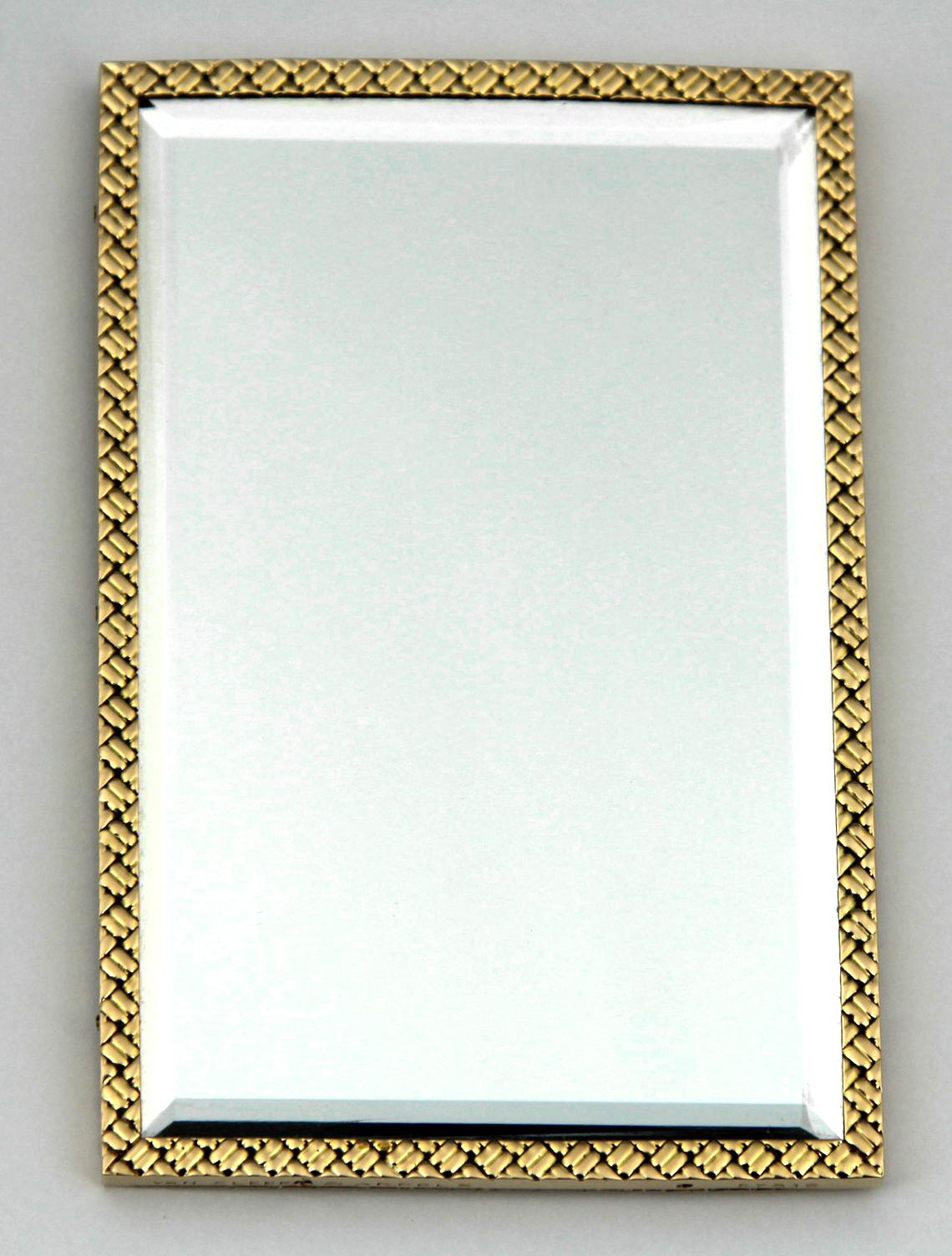 A Van Cleef & Arpels double-sided bevelled edge mirror, the 18ct yellow gold perimeter decorated with a crisscross block pattern design, the edge signed Van Cleef & Arpels, no. 57319, with suede slip pouch, 9cm x 6cm