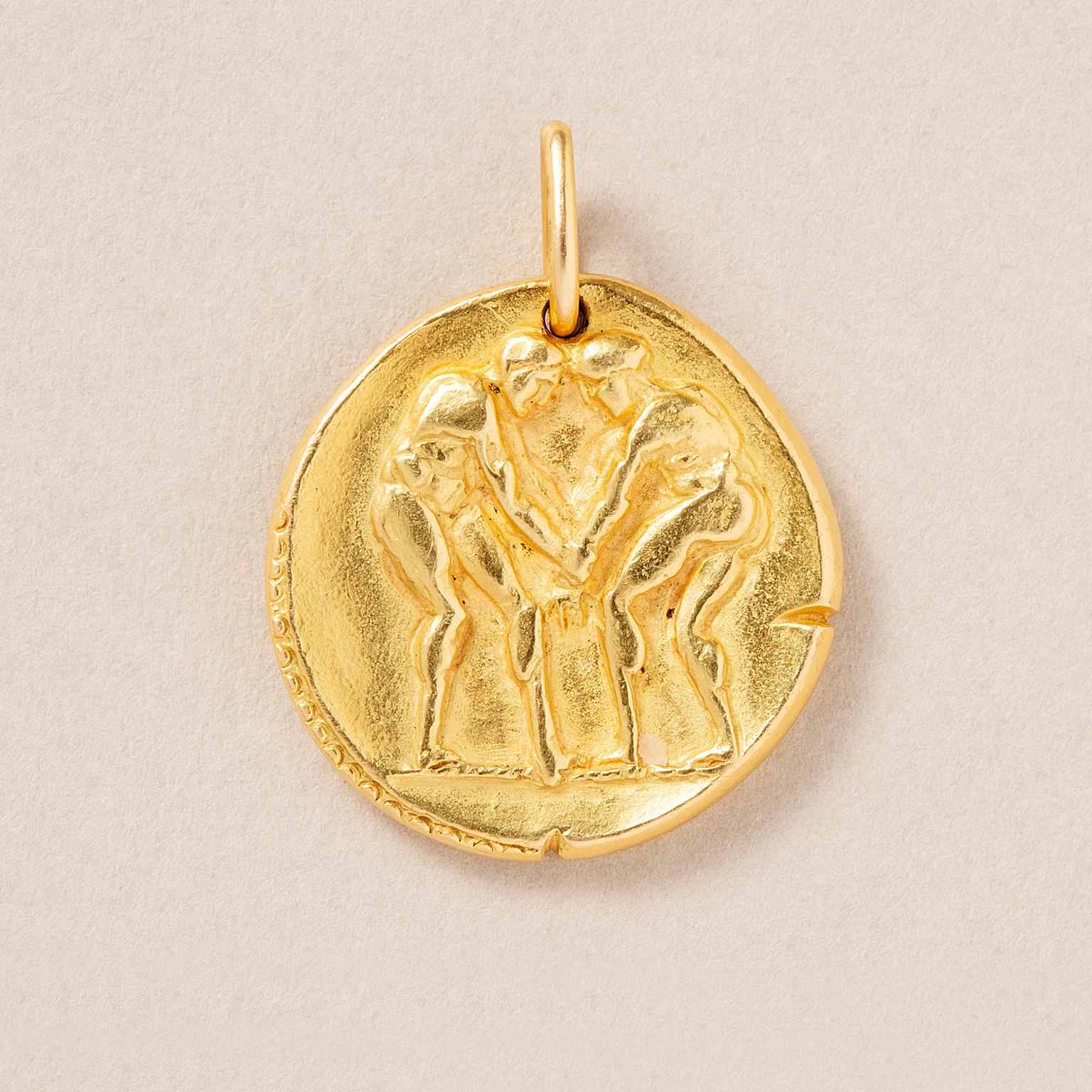 An 18 carat gold vintage gemini zodiac pendant, resembling an ancient coin, depicting two man facing each other in opposite direction and Roman numbers and the symbol for the Gemini sign on the back, circa 1970s, signed and numbered: Van Cleef &