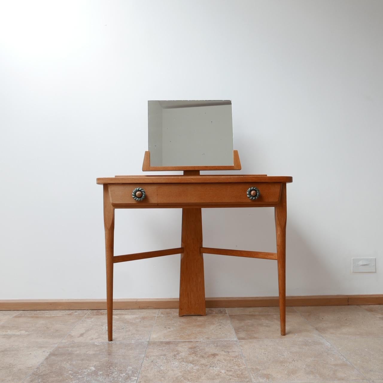 A vanity table by Guillerme et Chambron.

French, circa 1960s.

Immensely elegant three legged table.

Original ceramic drawer pulls and table top tiles.

Oak and ceramics.

The mirror can be removed for transport.

Small spotting to the