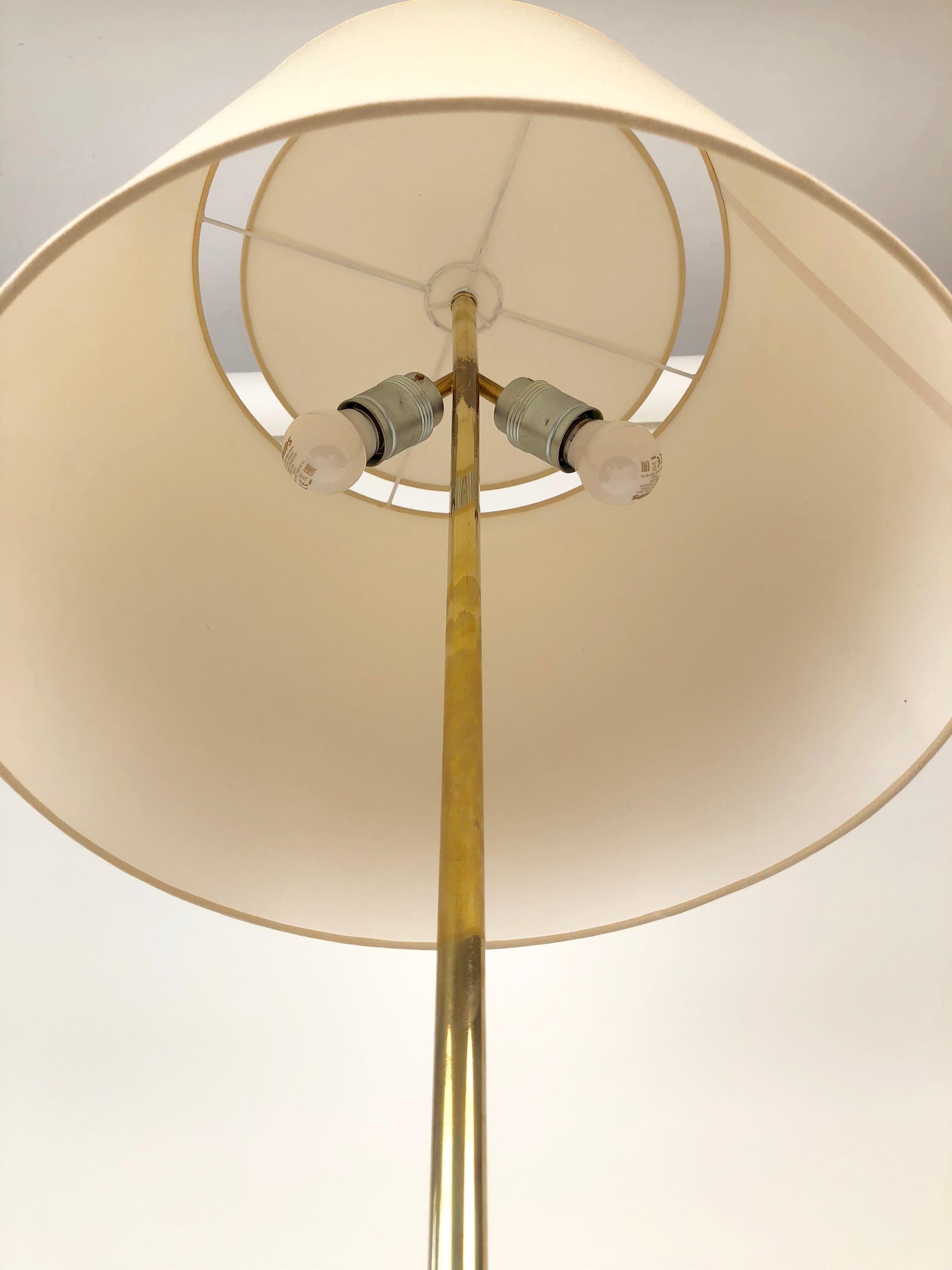 A tripod floor lamp, model No. 2003 from J.T. Kalmar, was manufactured between 1930 until 1960. This was a very popular model for Kalmar and there exists many variations with subtile differences. The lamp is composed of patinated, polished brass, a