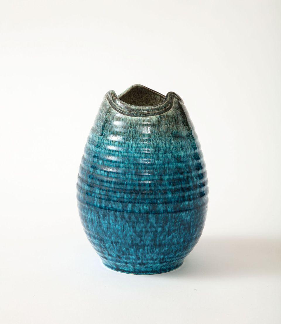 A ceramic vase/vessel in a beautiful green and turquoise produced by Accolay Pottery. Founded in the 1950s in Accolay, France, the Accolay studio became well known after it produced buttons for the collection of Christian Dior. One of several pieces