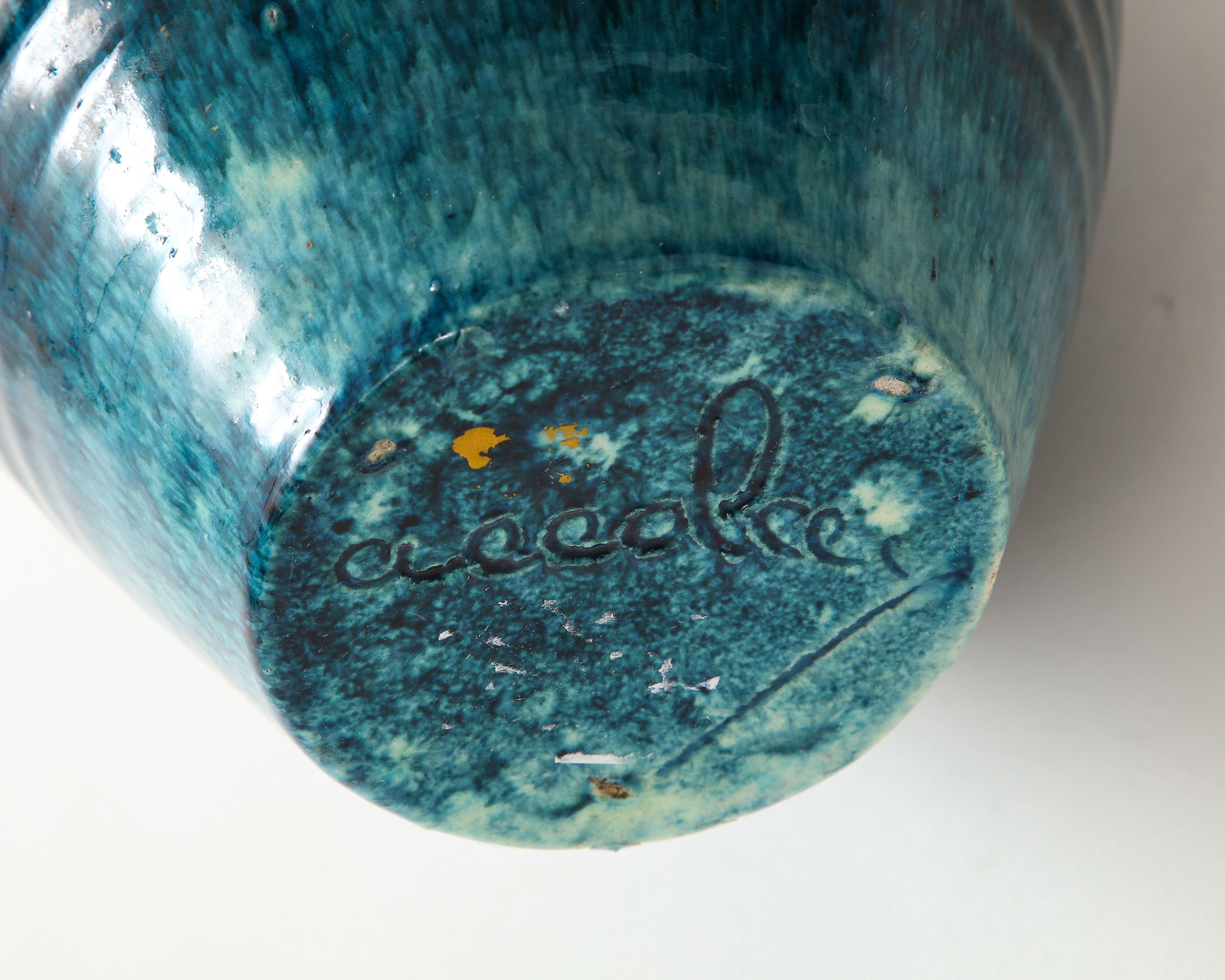 A ceramic vase in a beautiful glaze of blue and brown produced by Accolay Pottery. Founded in the 1950s in Accolay, France, the Accolay studio became well known after it produced buttons for the collection of Christian Dior. One of several pieces of