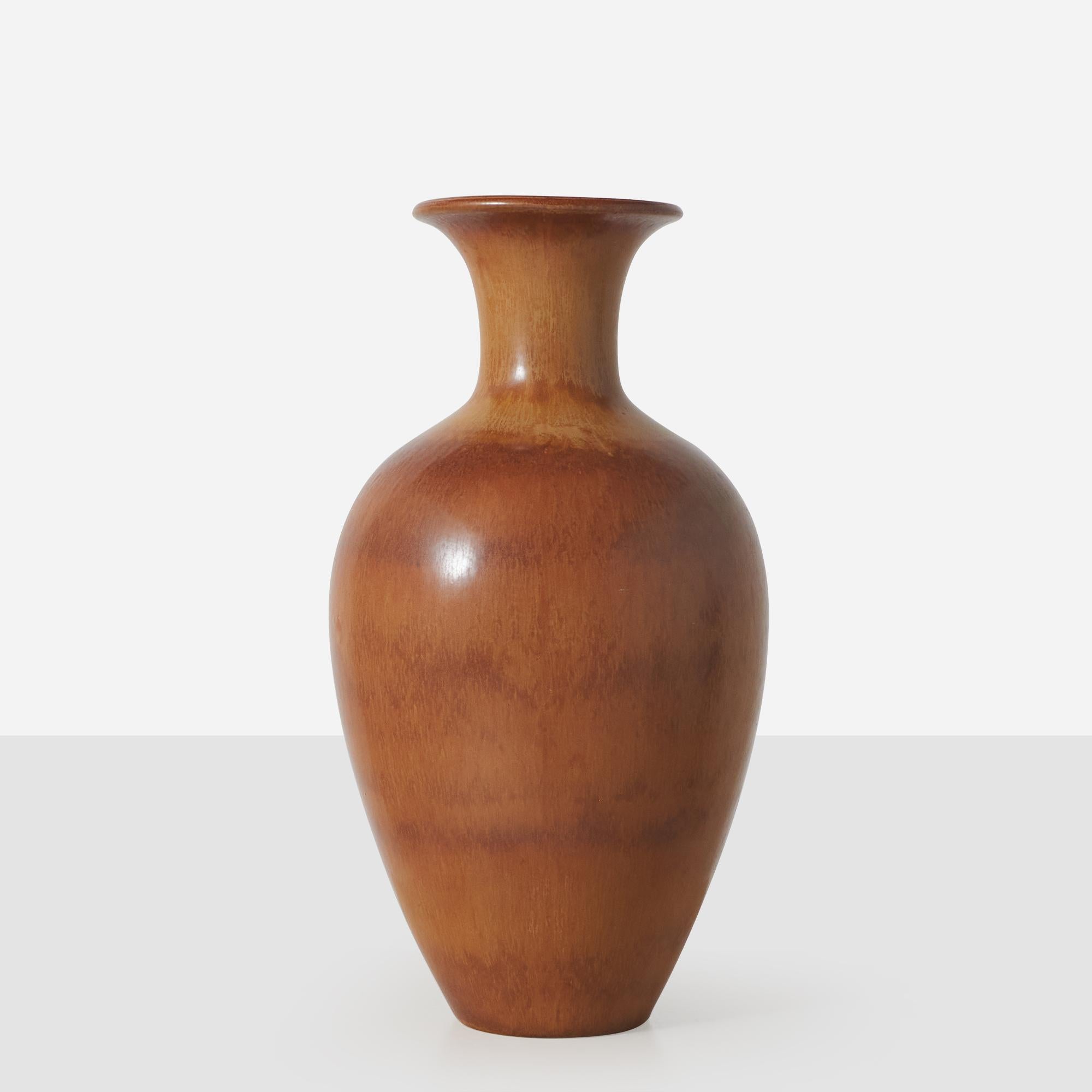 A brown, ochre, and auburn hare's fur glaze ceramic vase by Gunnar Nylund for Rorstrand. Signature and Studio mark to to bottom. Several firing marks are present. 