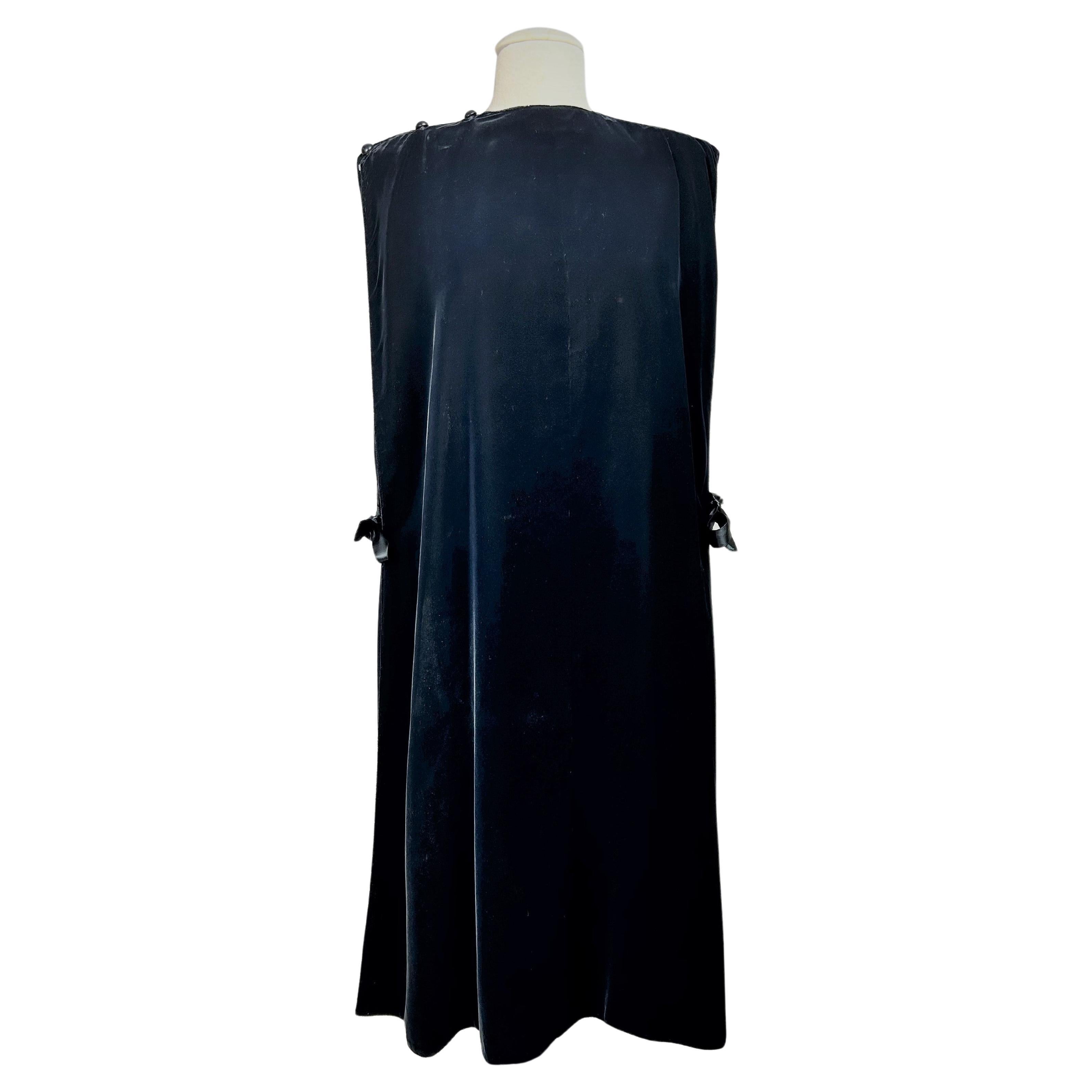 Circa 1980

France

Elegant black silk velvet Chasuble evening dress by Madame Grès Haute Couture (attributed to) dating from the 1980s. Minimalist Chasuble cut with two large triangular panels buttoned at one shoulder. The black cut silk velvet