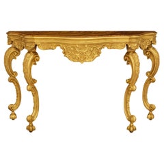 A Venetian 18th century Giltwood and faux painted marble console