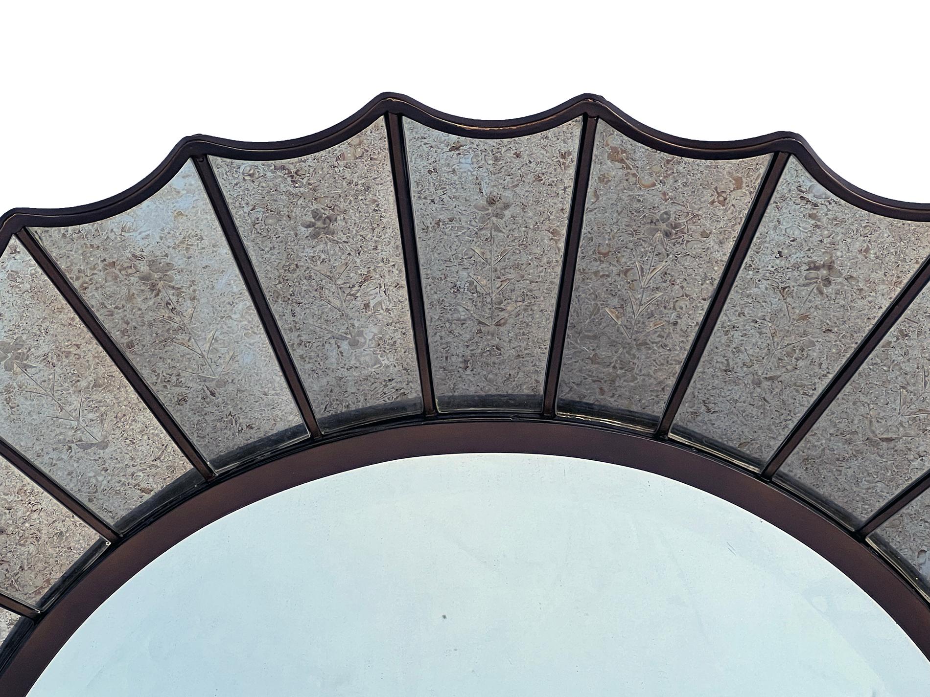 the round beveled central plate within a scalloped mirrored frame of reverse-etched panels