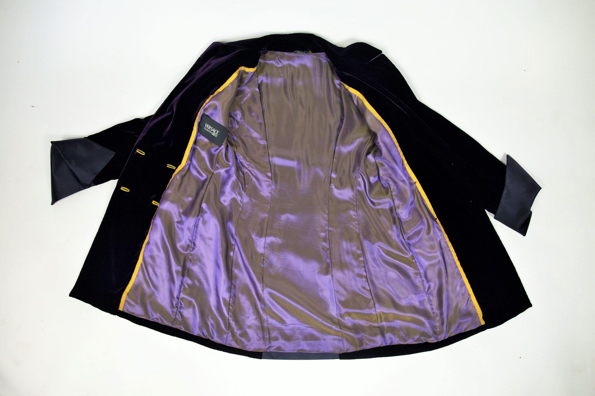 Circa 2000/2005
Italy

Beautiful evening tuxedo jacket out of purple cardinal velvet from the famous Milanese House directed by Donatella Versace. Italian chic for this long jacket with crossed sides and double breasted trimmed with yellow satin.