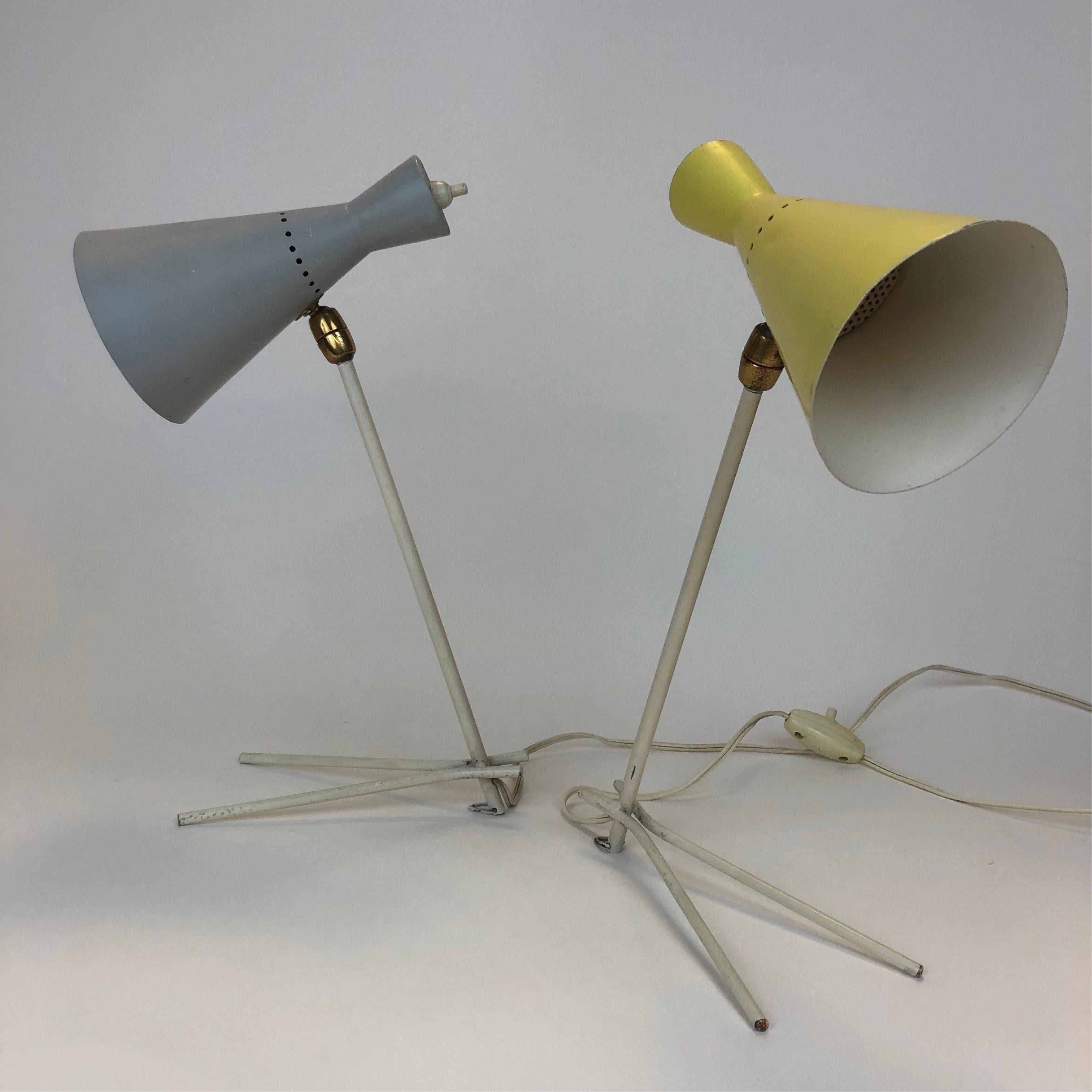 A pair of Stilnovo table lamps with gray and yellow powder coated spun aluminum shades and iron rod bodies with hoops for being hung as sconces Both are in recently rewired vintage original condition and retain their original ceramic insulator