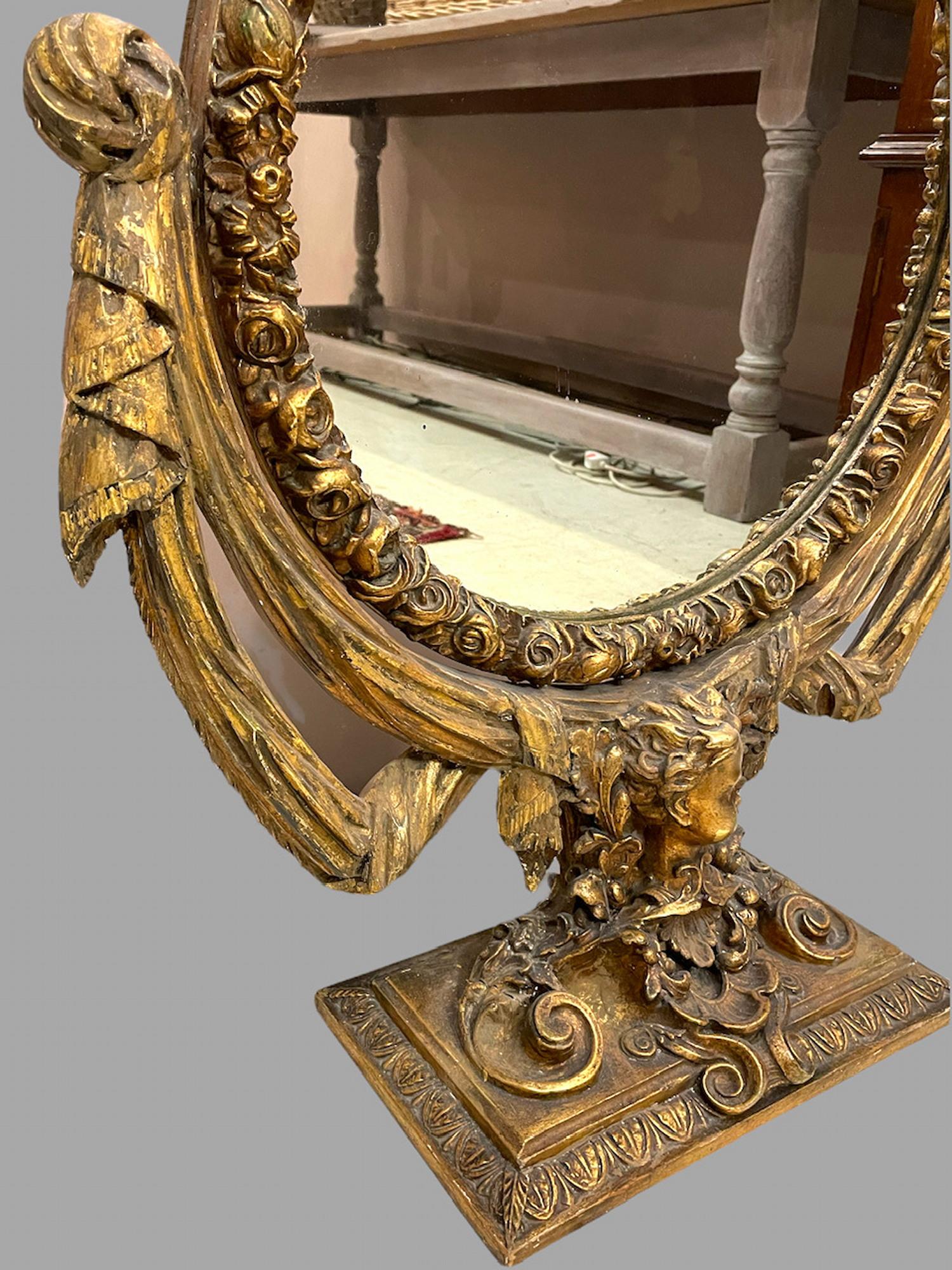 A very attractive early 20th C dressing table mirror heavily decorated with Swags and a Cherub to base.