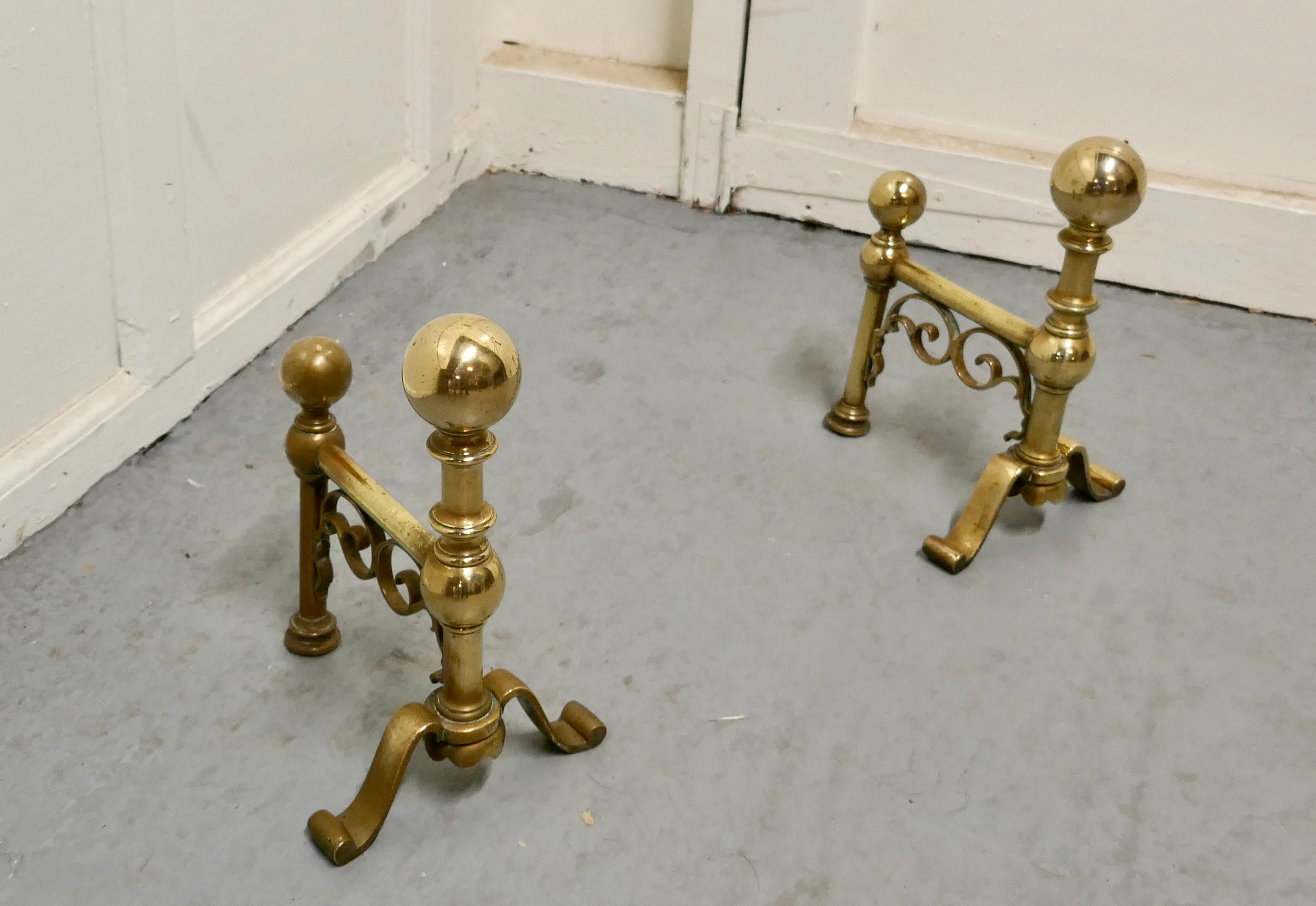 A very attractive pair of brass andirons

An elegant pair of 19th century andirons or fire dogs
This very attractive pair of brass andirons they are 11” high, 10” long and 10” wide across the front, they are in excellent but obviously used