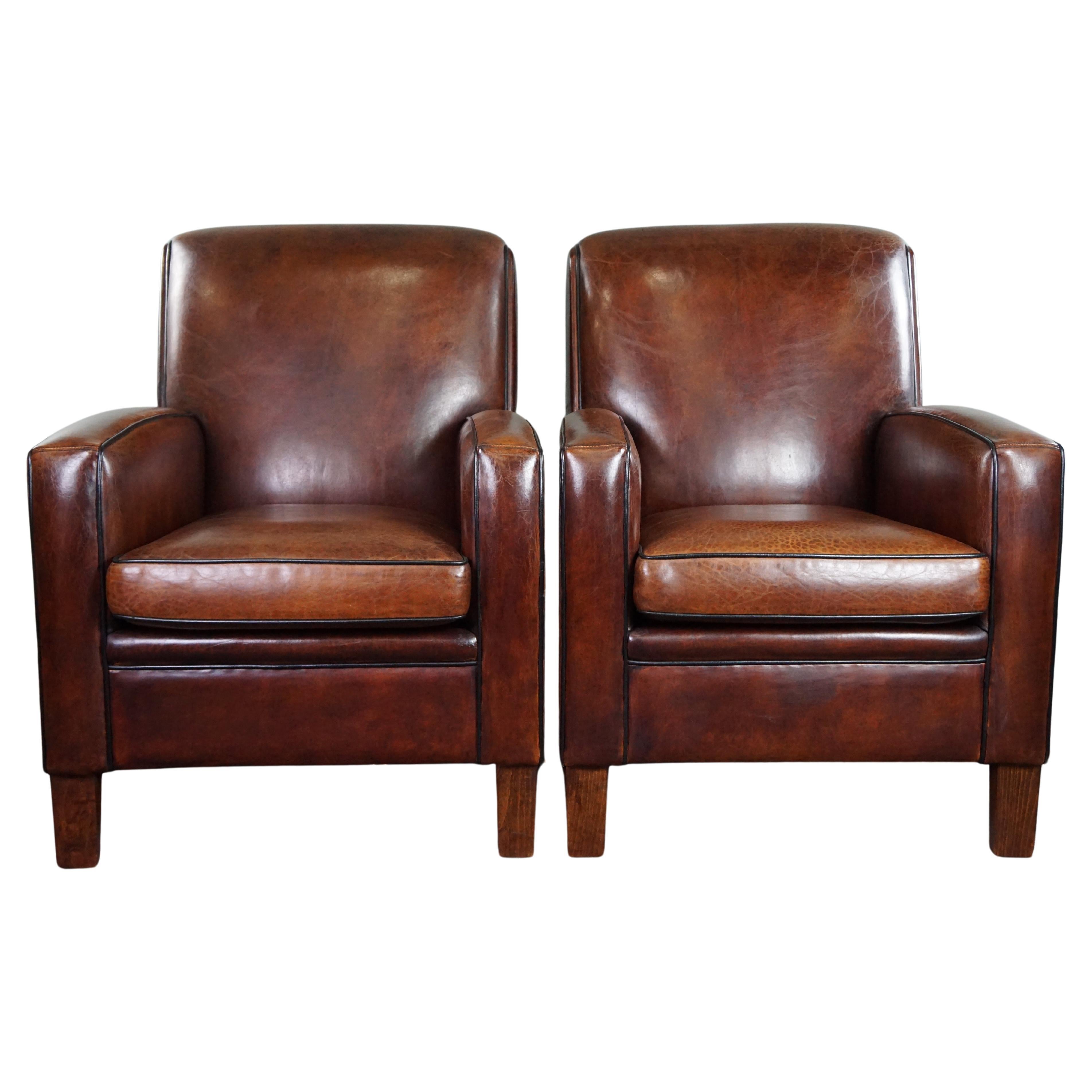 A very beautiful set of 2 Art Deco design armchairs in sheep leather