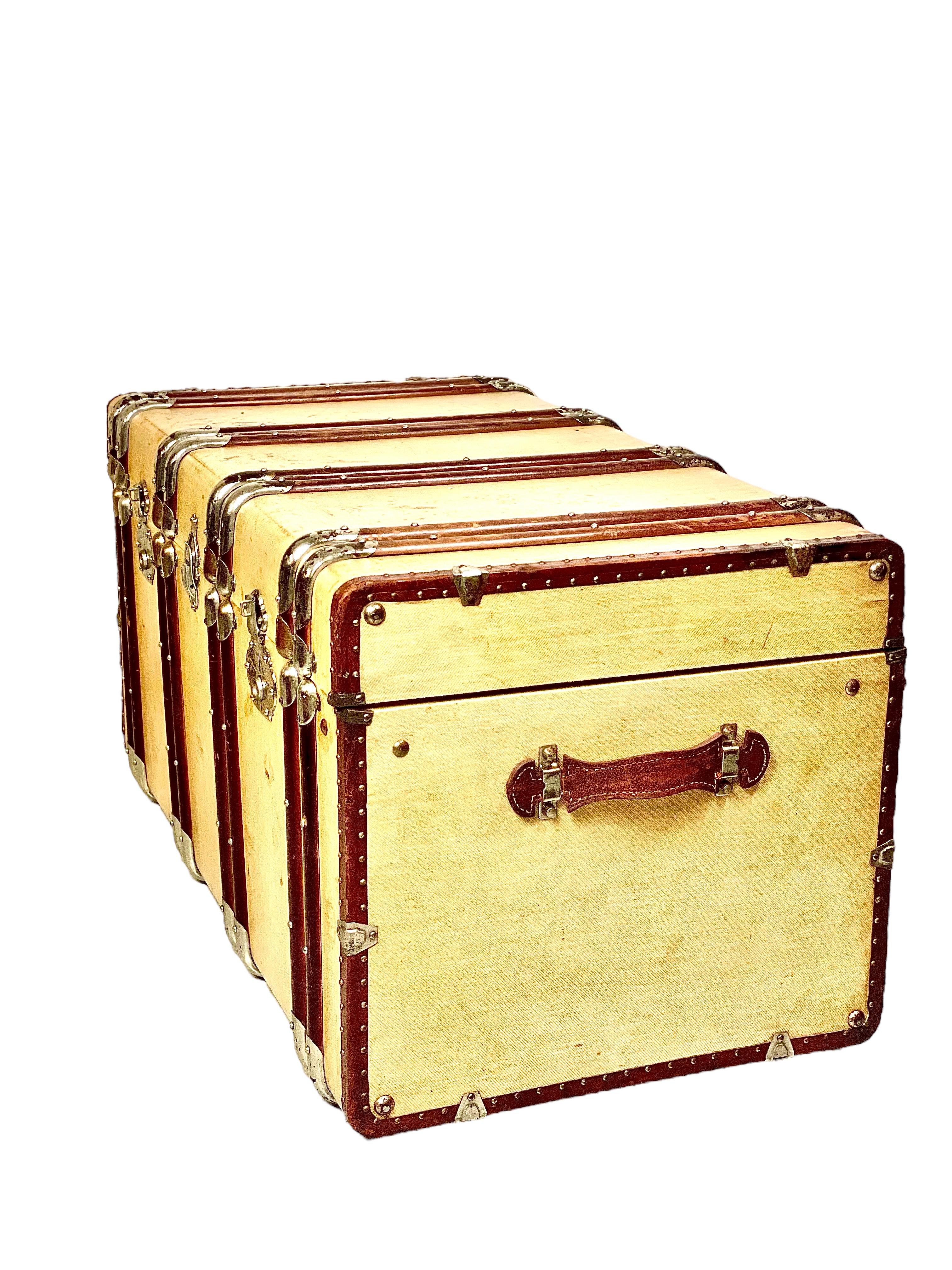 A very chic canvas-covered wooden steamer trunk, complete with sturdy leather carrying handles and very attractive vertical wood and brass banding. This wonderful vintage travelling trunk dates from the 19th century, and features a green
