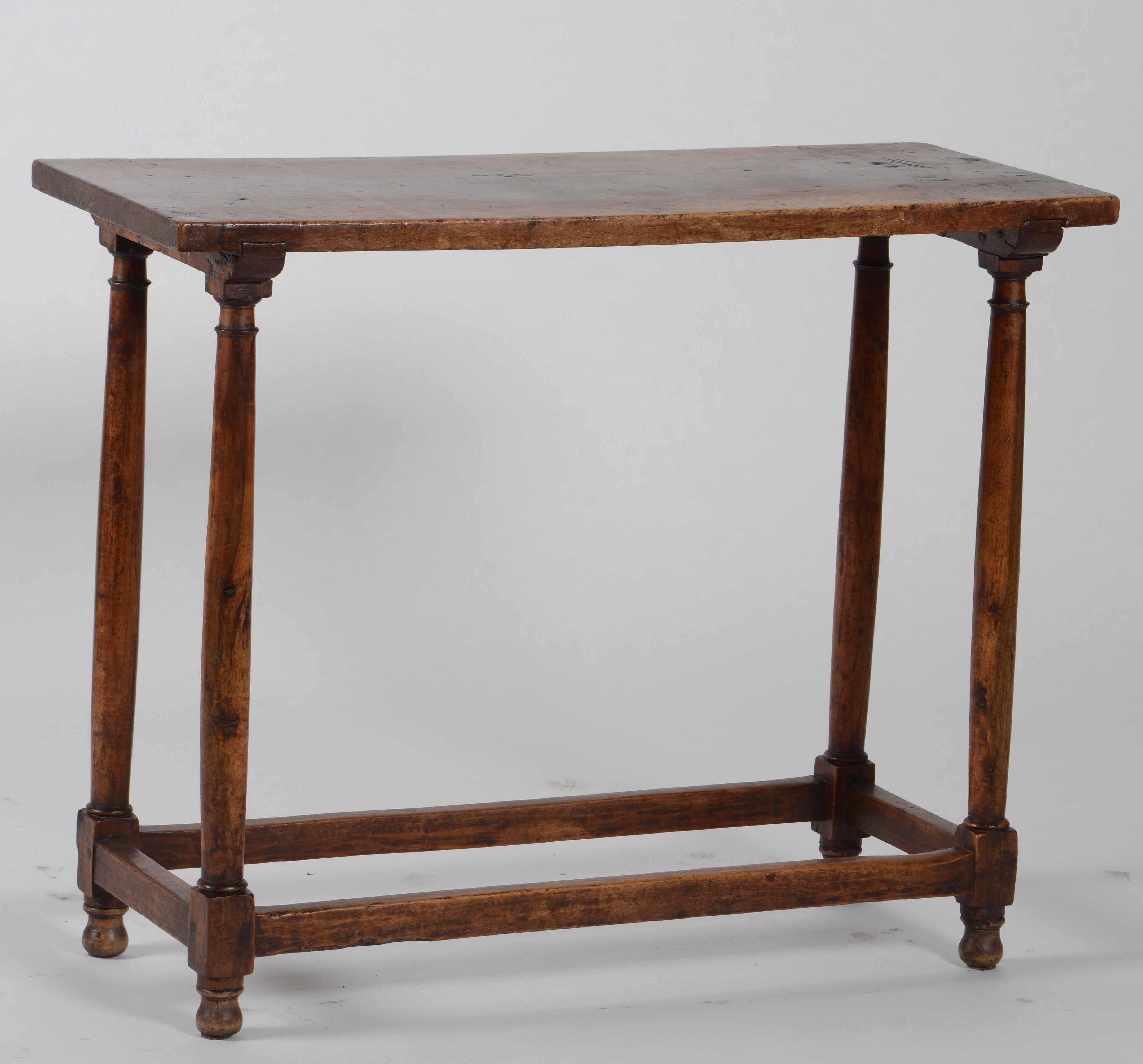 A very elegant small console table in walnut . Beautiful patina, works in a traditional or contemporary setting.