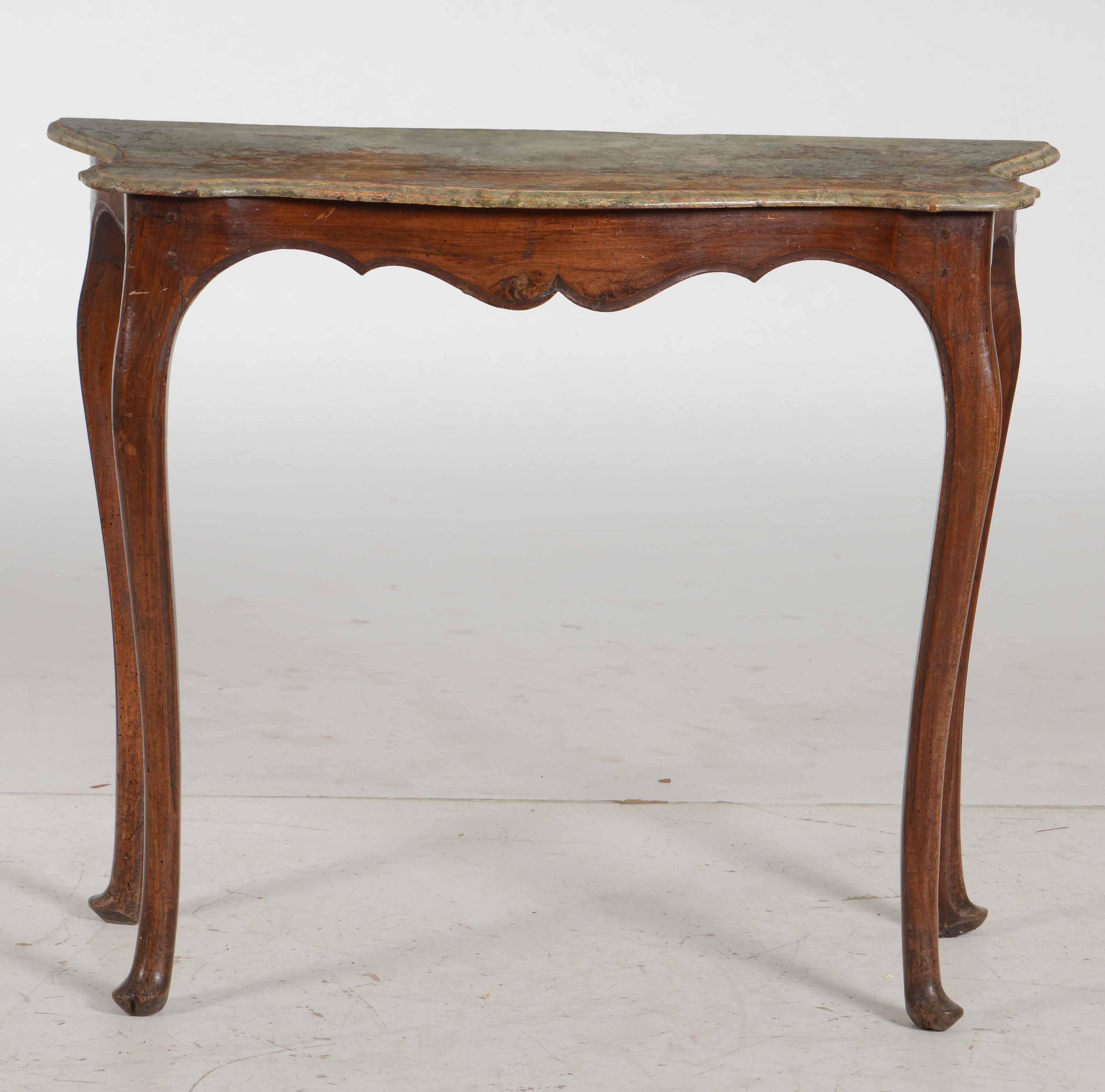 A very elegant 18th century small console table in walnut with original faux marble painted top. Beautiful soft lines, works in a traditional or contemporary setting.