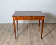 A very elegant walnut table/desk with a central drawer