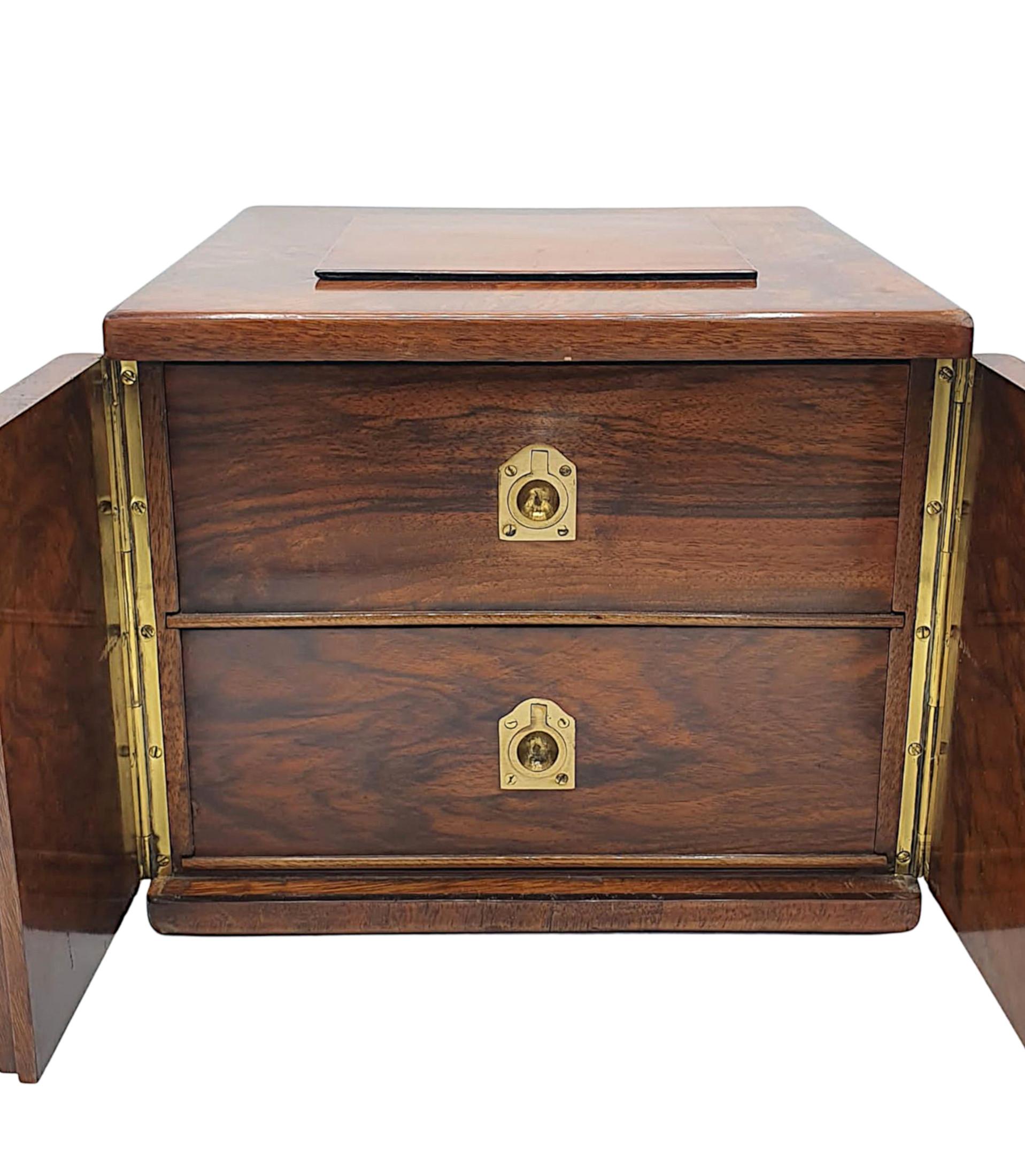 A very fine 19th century burr walnut cigar box of square form, the moulded top raised over a pair of brass hinged doors opening to reveal two cockbeaded drawers with fitted interiors and mounted with flush brass pulls. The sides of cigar box also