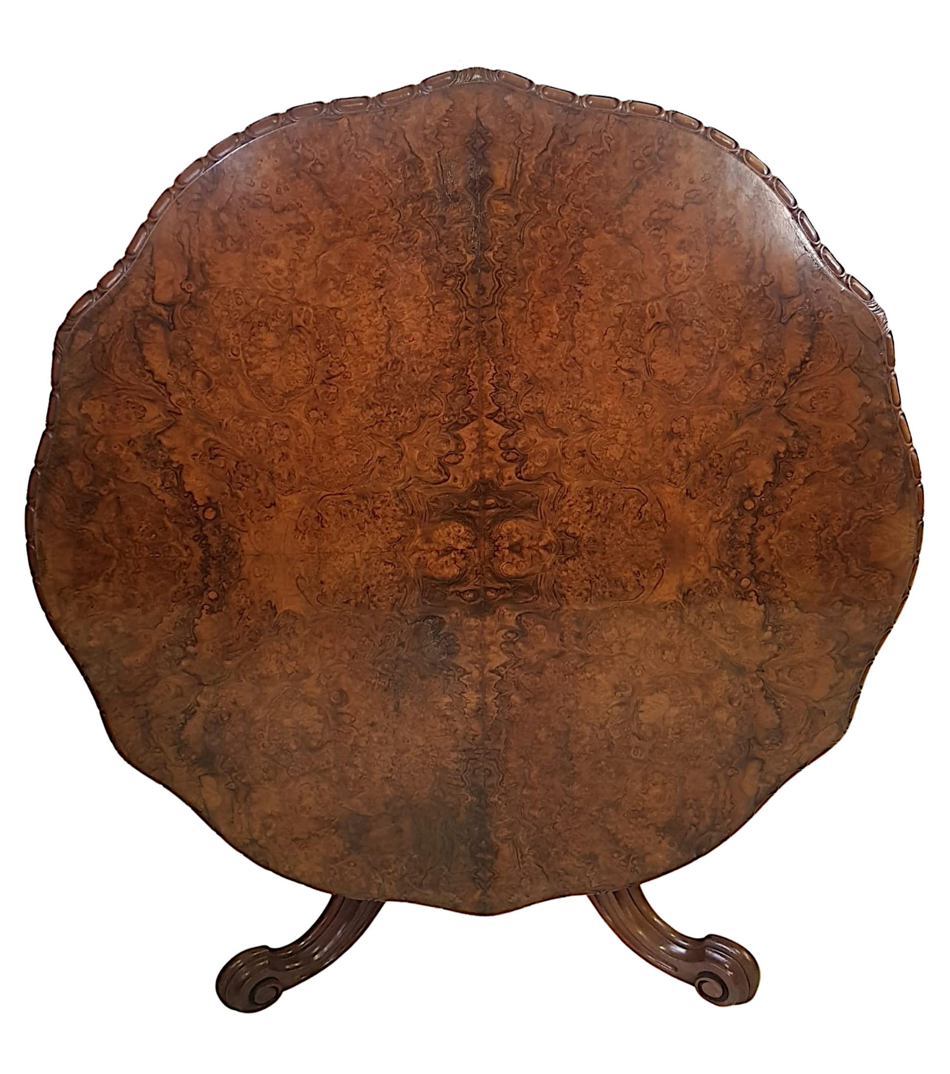 A very fine 19th century burr walnut flip top dining table. The shaped moulded top with carved bead and foliate motif border above moulded frieze supported on finely carved ring turned baluster pod with gadroon motif detail supported on trefoil