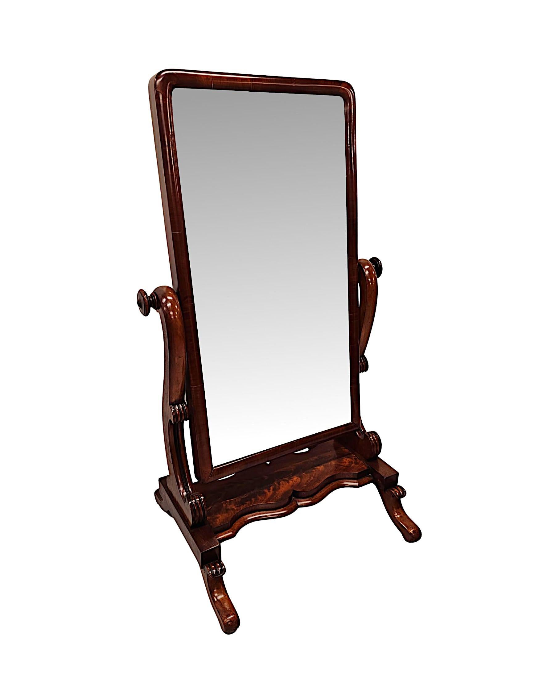 A very fine 19th Century flame mahogany cheval mirror fabulously hand carved, of exceptional quality with gorgeously rich patination and grain.  The bevelled mirror glass plate of rectangular form is set within a finely figured and elegantly simple,