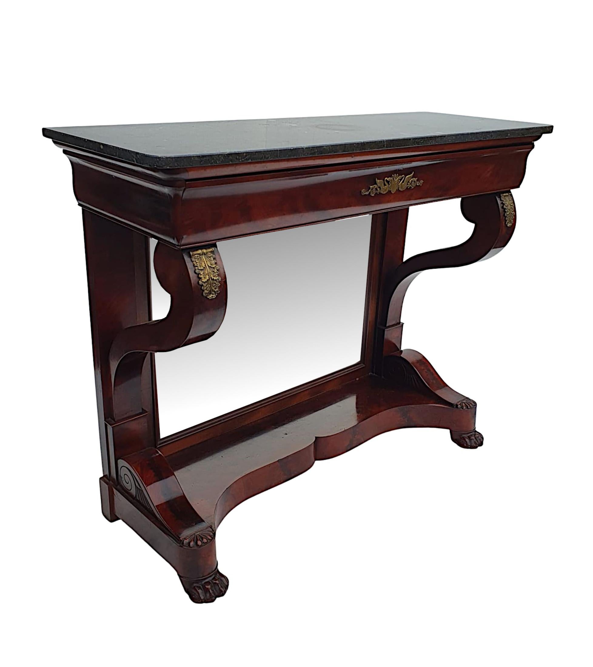 A very fine 19th Century flame mahogany console table. The moulded Marquina Black marble top raised over curved frieze with full width single long drawer and centred ornate ormolu mount depicting a pair of swans and foliate detail. Supported above