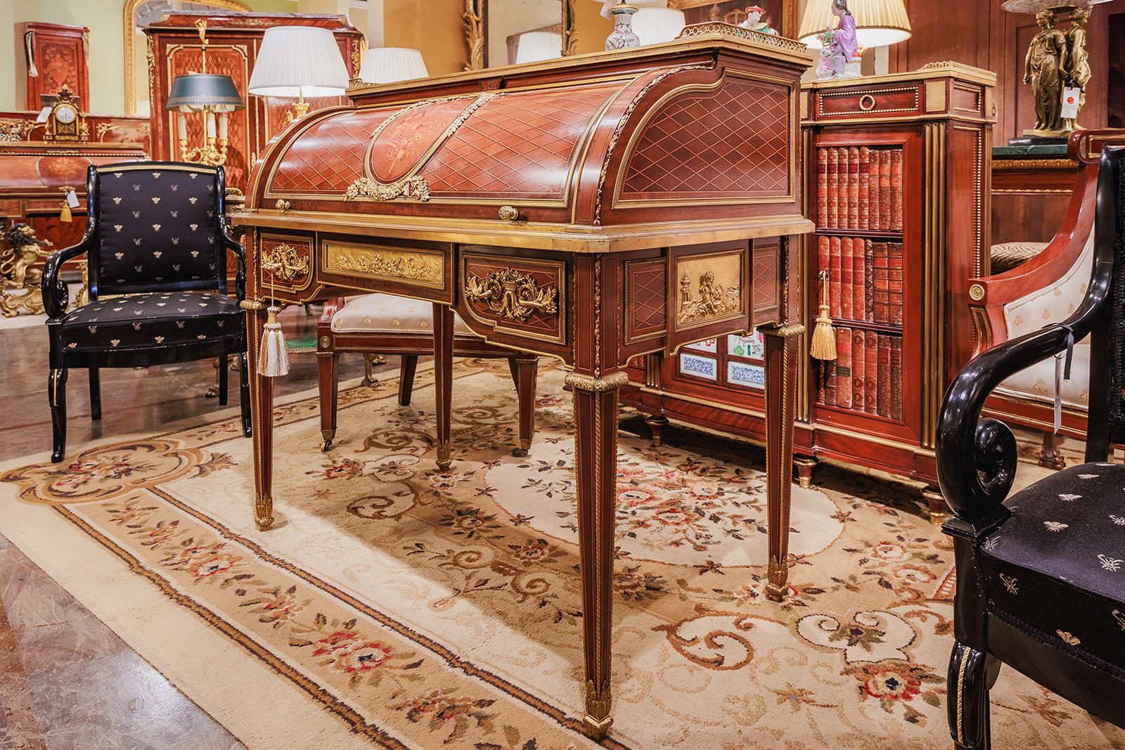 A very fine 19th century French Louis XVI mahogany and gilt bronze mounted roll top desk by Francois Linke . The finest gilt bronze mounts with a marquetry center panel of floral design . The interior with the original leather top and pigeon hole