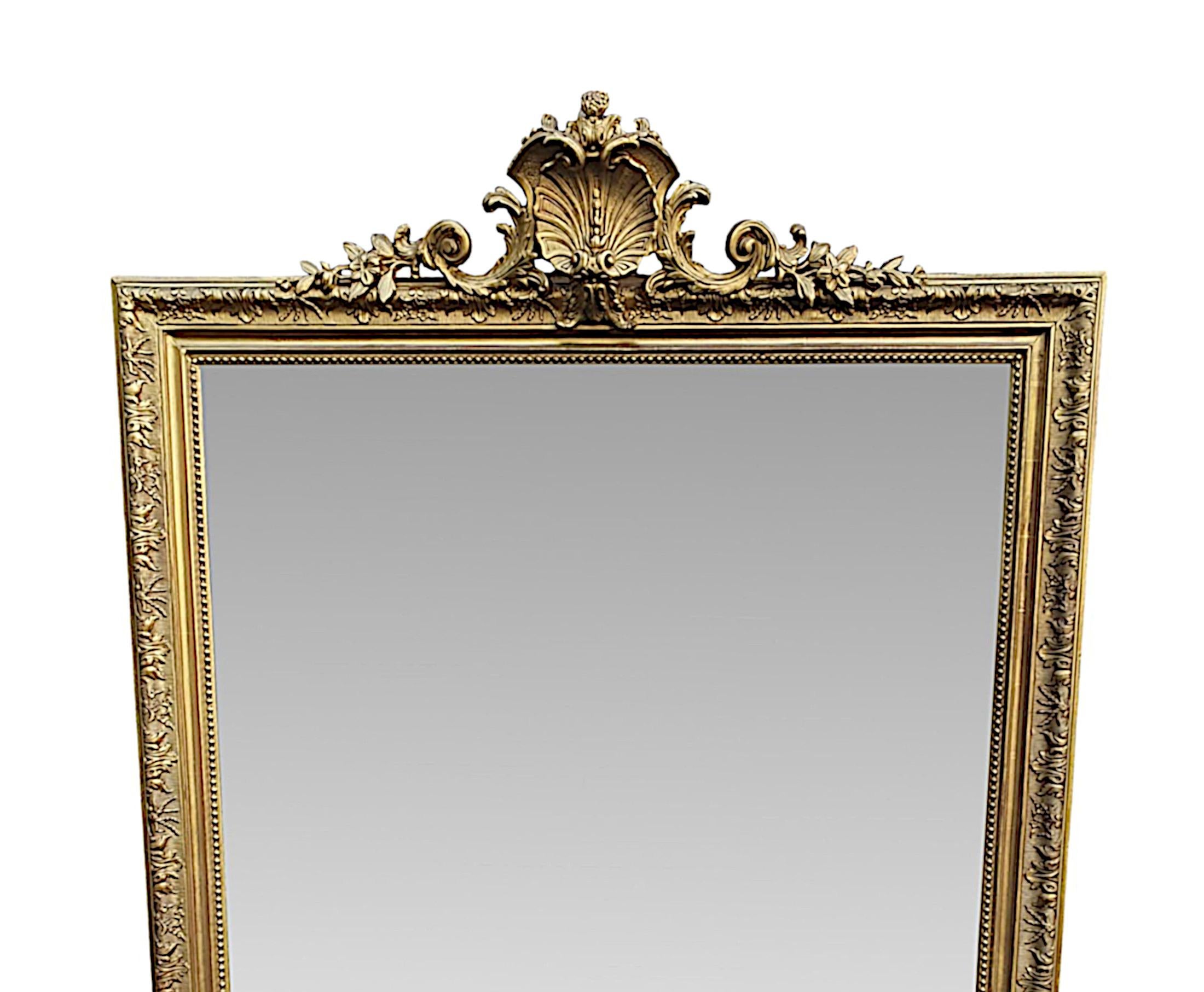 A very fine 19th century giltwood overmantle or hall mirror of rectangular form. The mirror glass plate is set within a hand carved and moulded giltwood frame with beaded detail and a further outer border embellished with intricate floral and ruffle