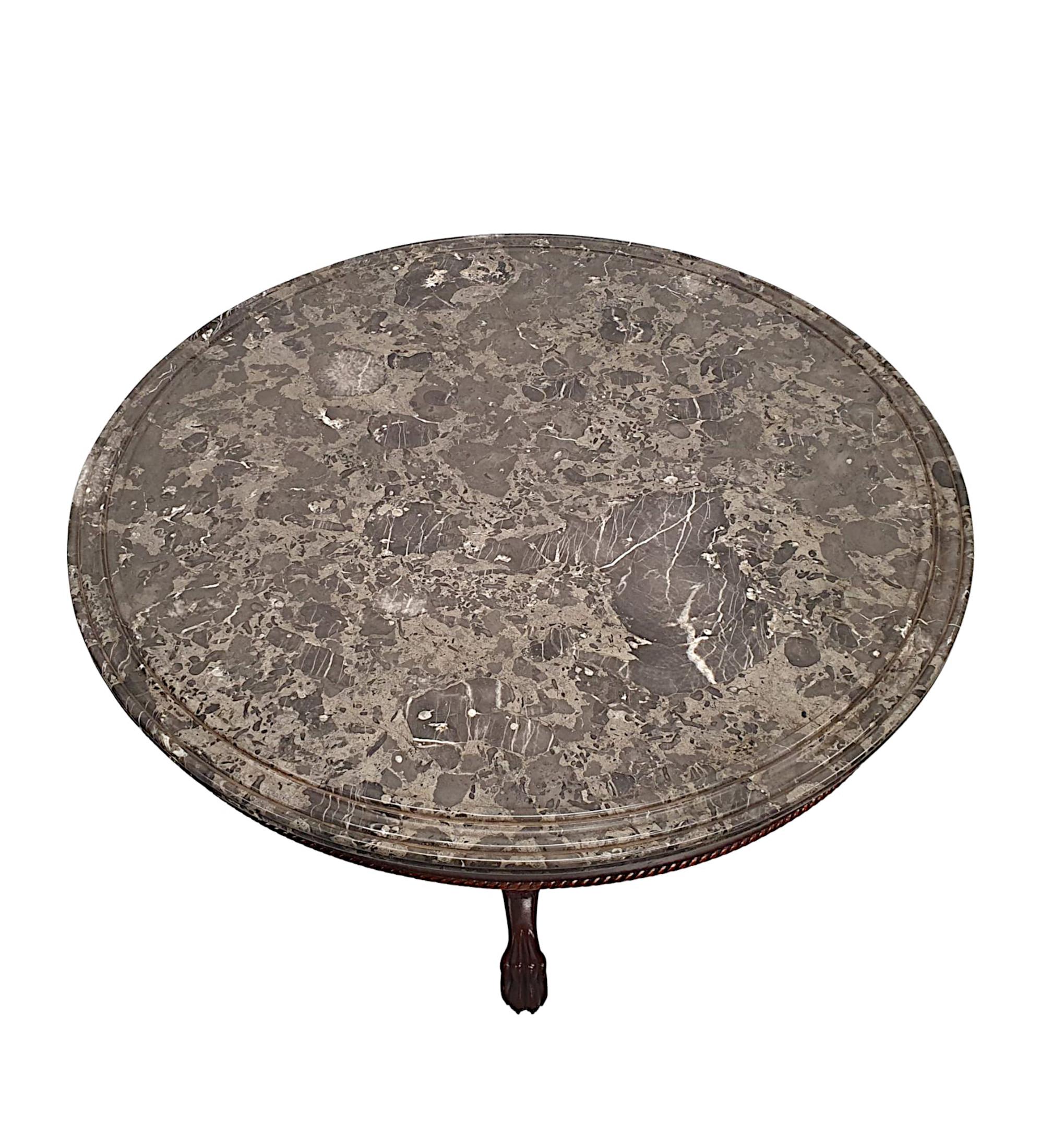 A very fine 19th century mahogany marble top centre table, of fantastic quality and finely hand carved with beautifully rich patination and grain. The gorgeous moulded and fluted emperador marble top of circular form with concentric ring detail to