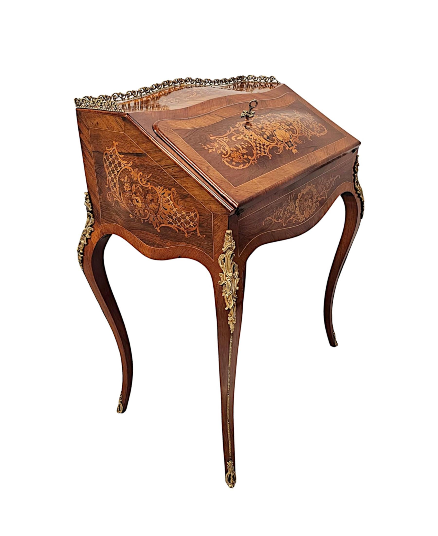 A very fine 19th Century richly patinated fruitwood Bureau Du Dame.  This gorgeous writing desk is of exceptional quality, stunningly hand carved, line inlaid, ormolu mounted and with marquetry panels depicting intricate motifs of shells, flower